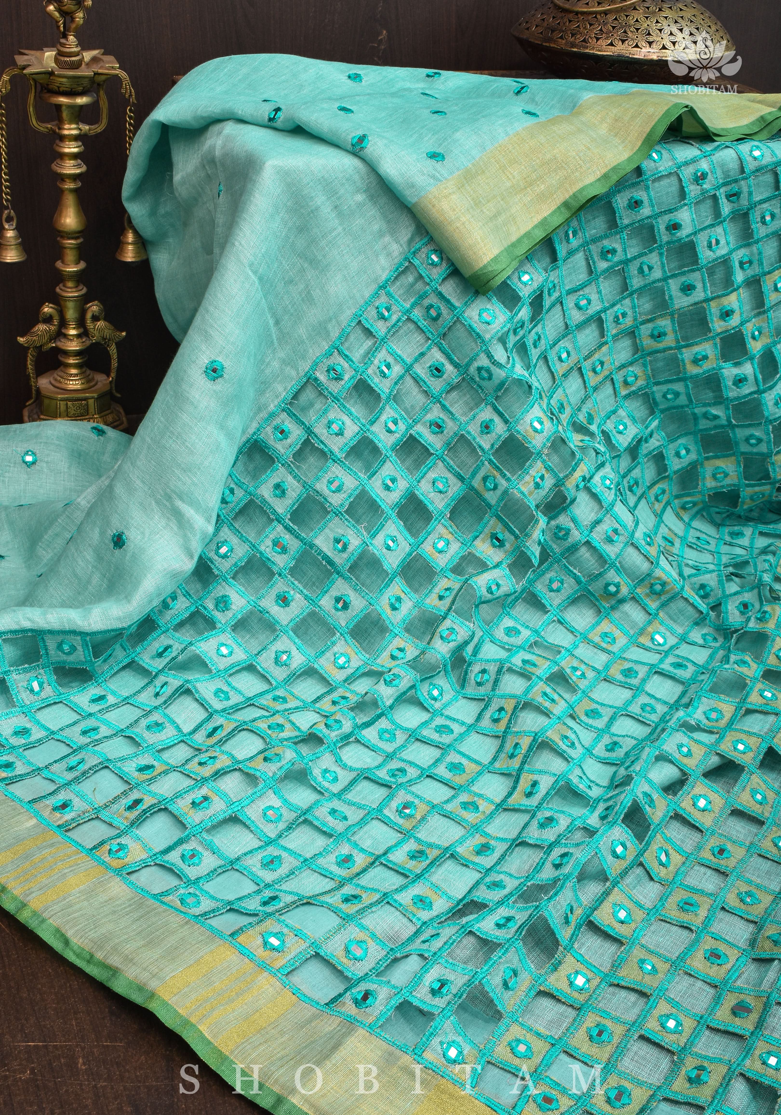 Jaali Pallu - Cutwork and Mirrorwork Saree in Linen by Linen in Teal Color | Shobitam
