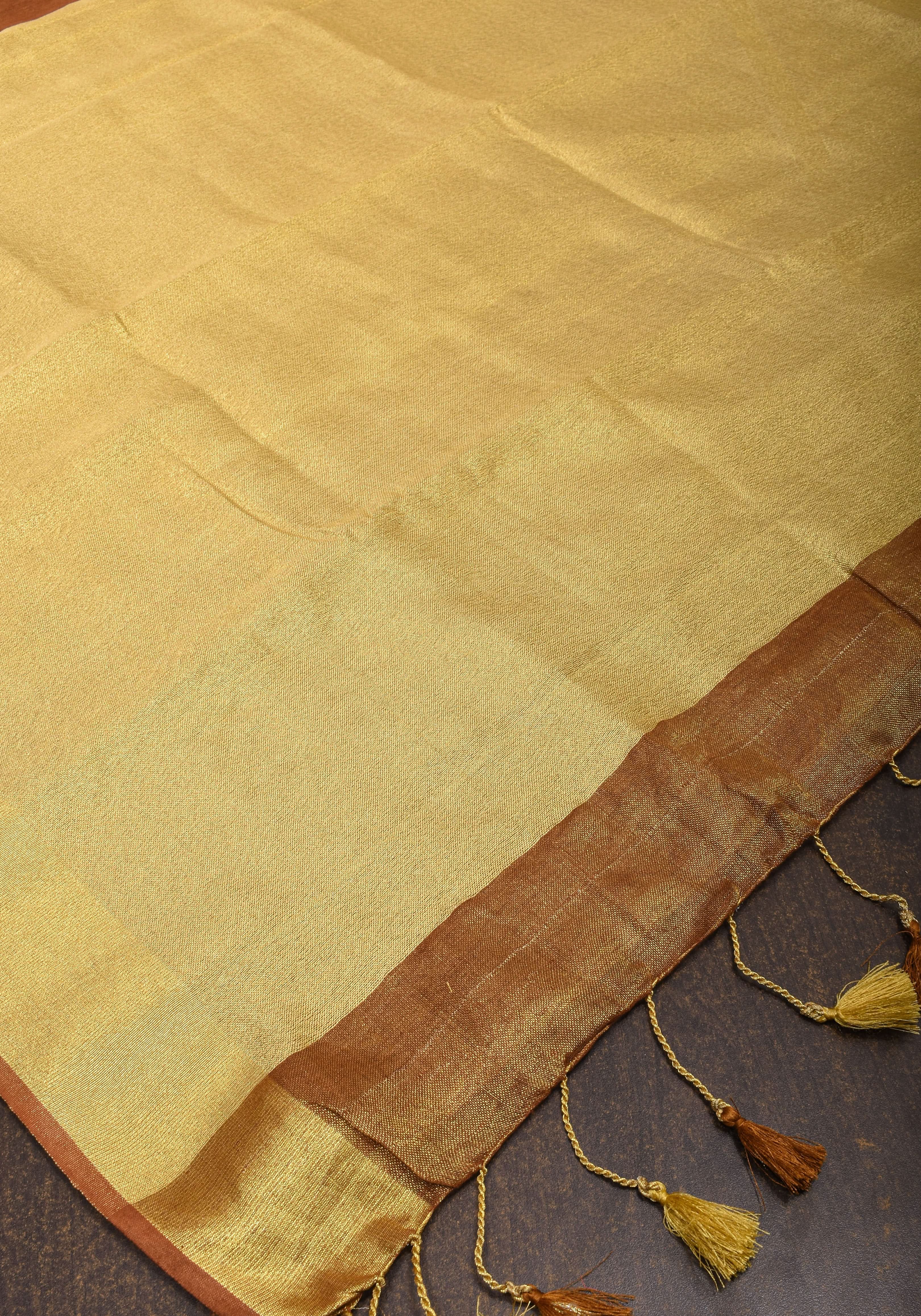 Caramel and Gold Tissue Linen Saree with Zari Border and long tassels | Shobitam