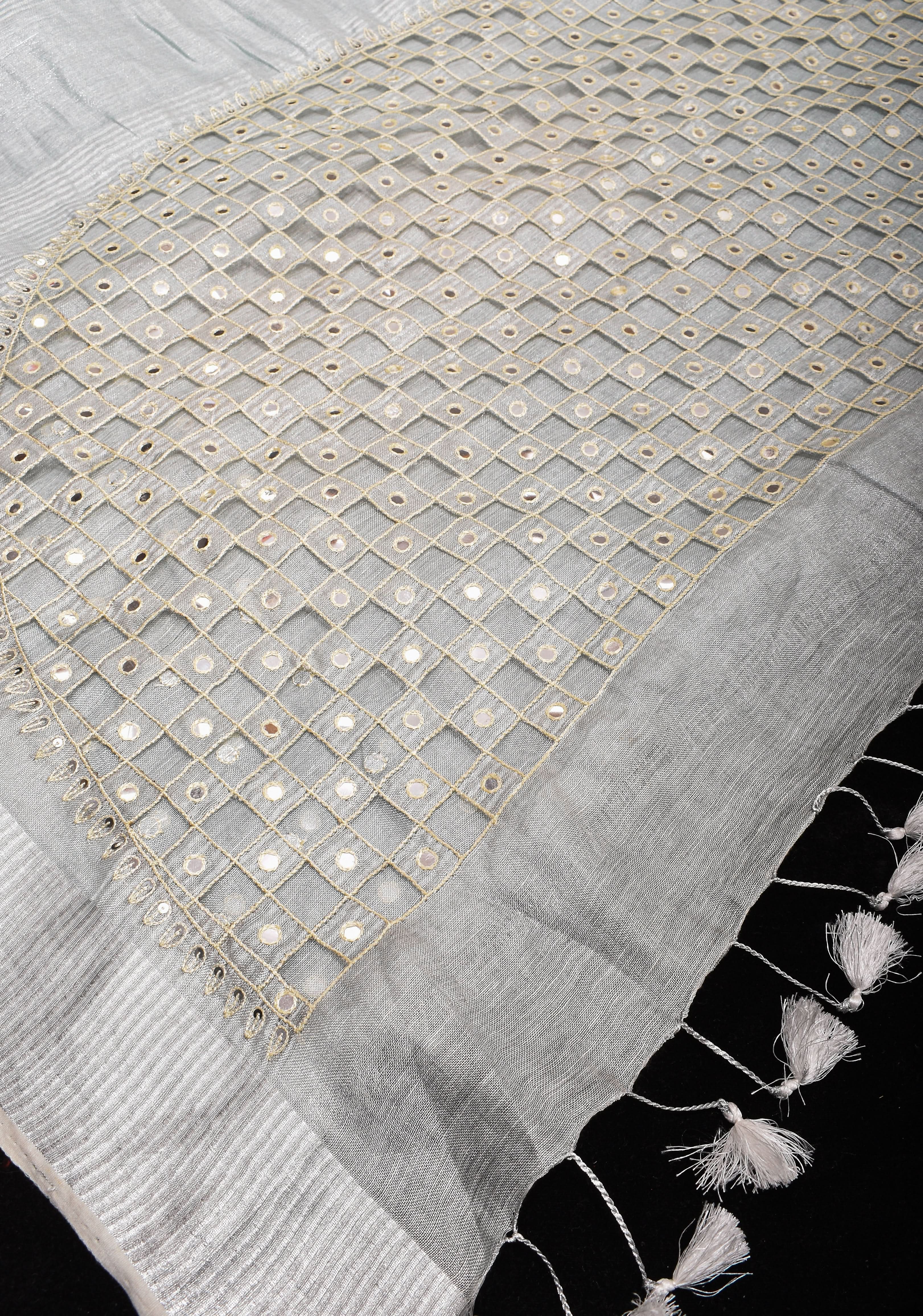 Cutwork and Mirror Work Tissue Linen Saree in White Silver with dramatic tassels | Shobitam
