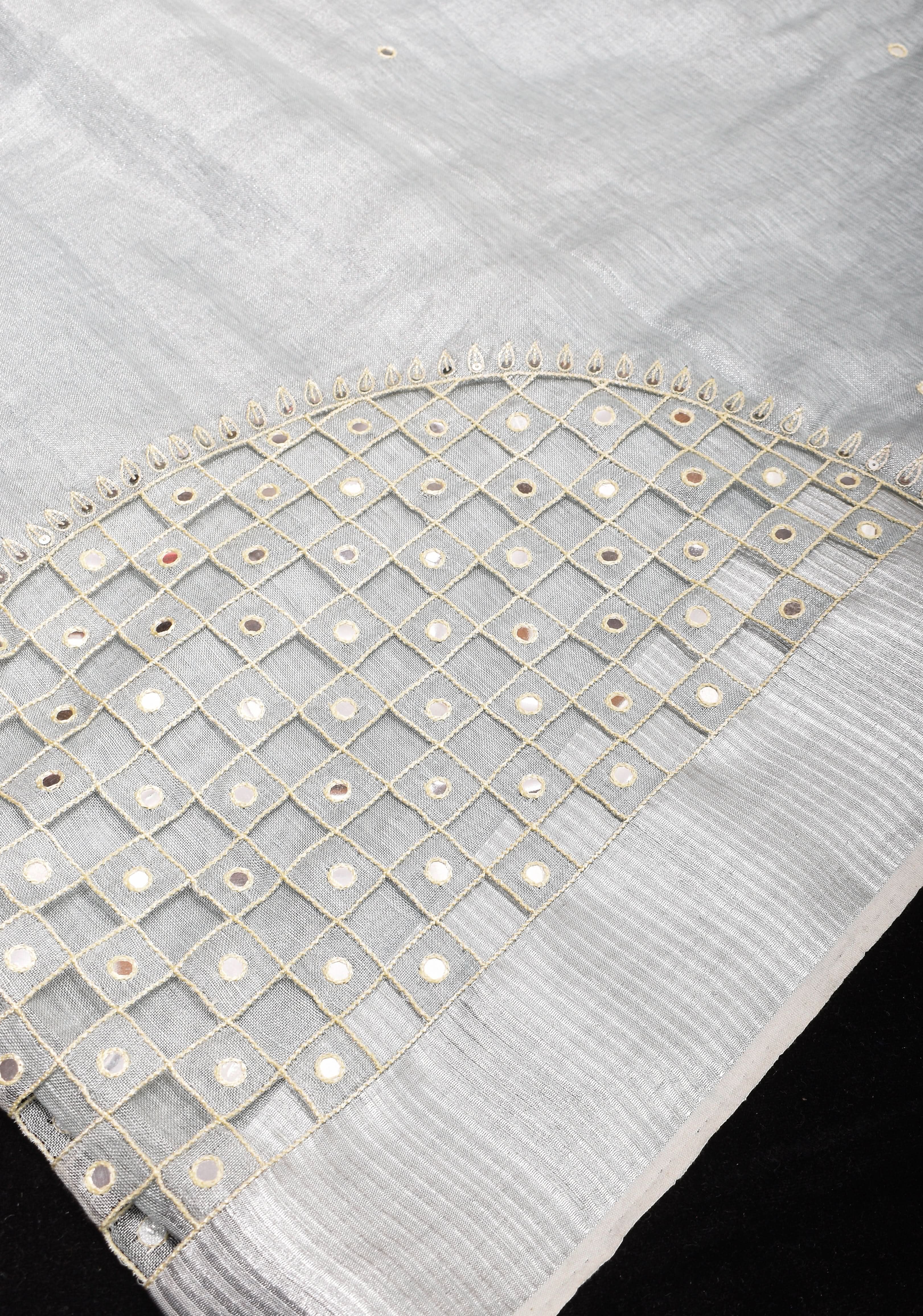 Cutwork and Mirror Work Tissue Linen Saree in White Silver with dramatic tassels | Shobitam