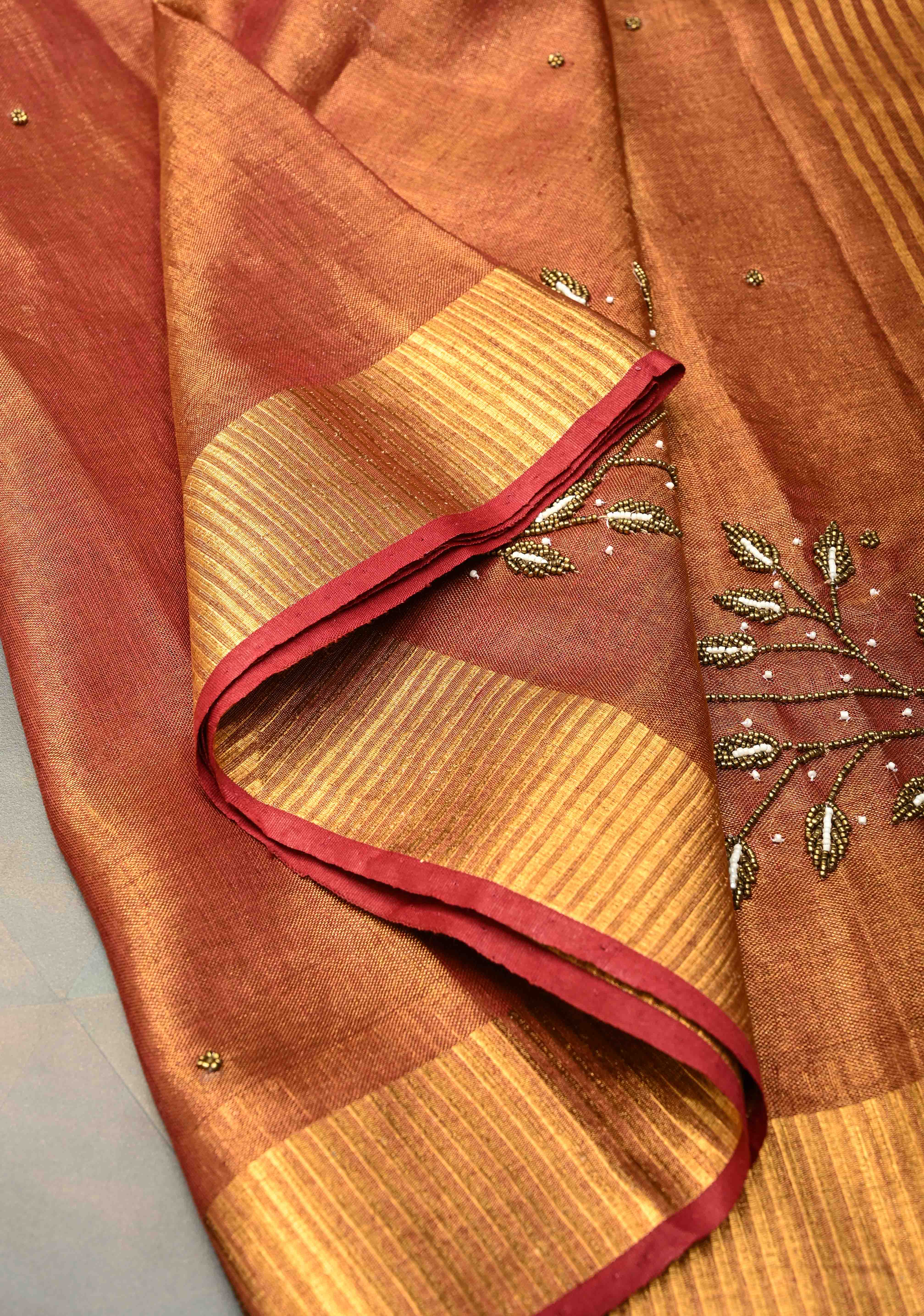 Golden Tissue Linen Saree in Reddish-Brown with Bead Embellishments | Shobitam