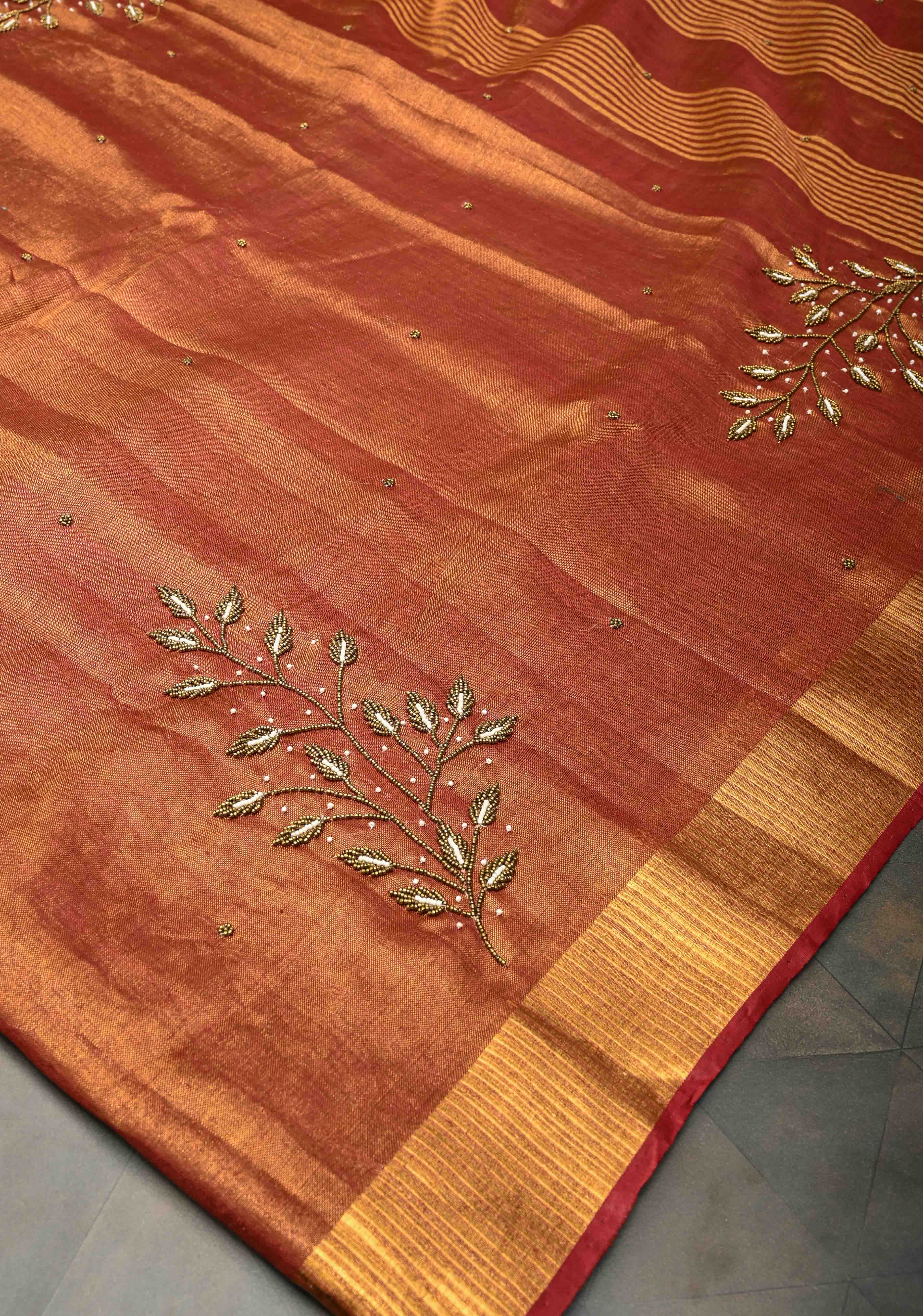 Golden Tissue Linen Saree in Reddish-Brown with Bead Embellishments | Shobitam