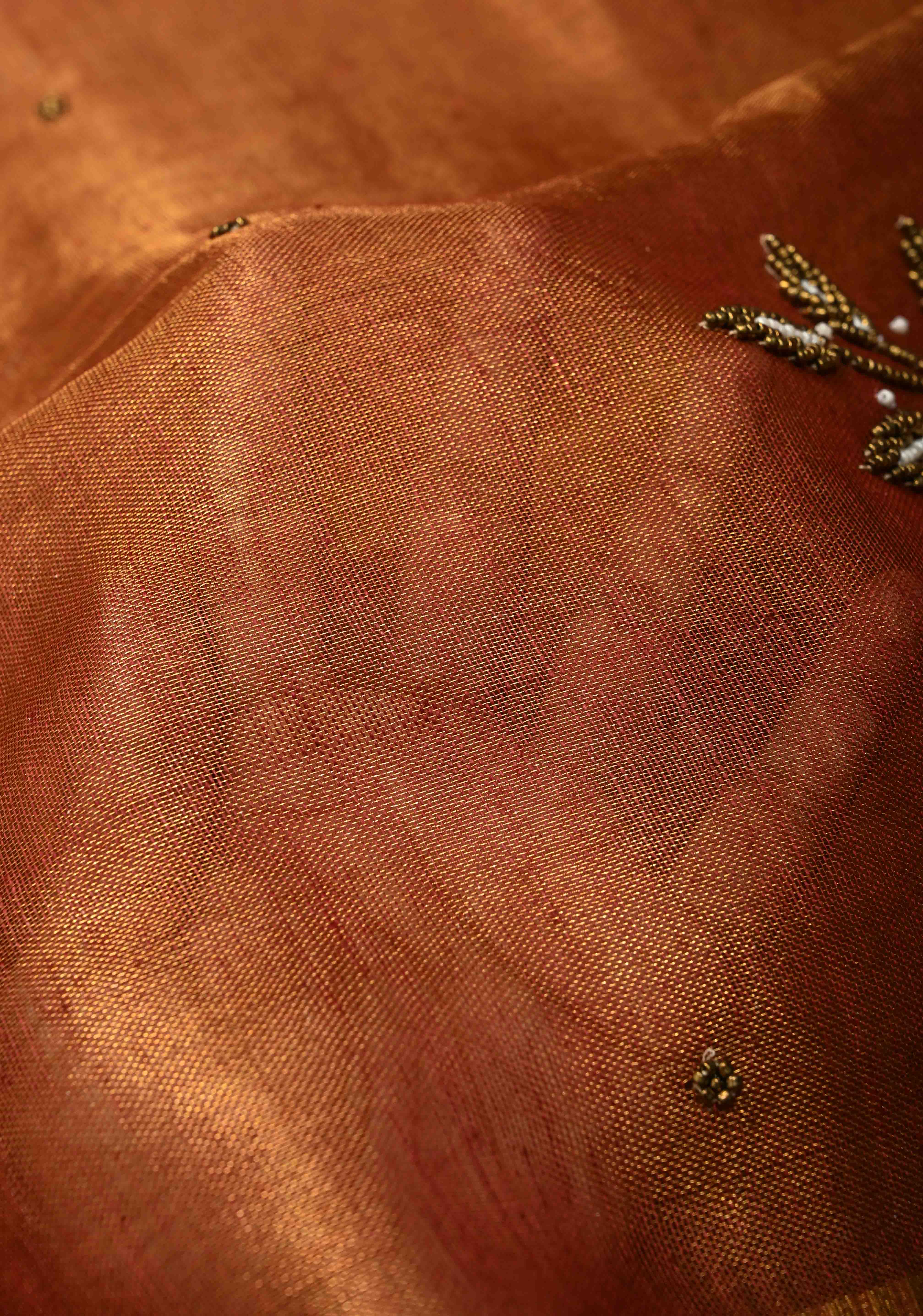Golden Tissue Linen Saree in Reddish-Brown with Bead Embellishments | Shobitam