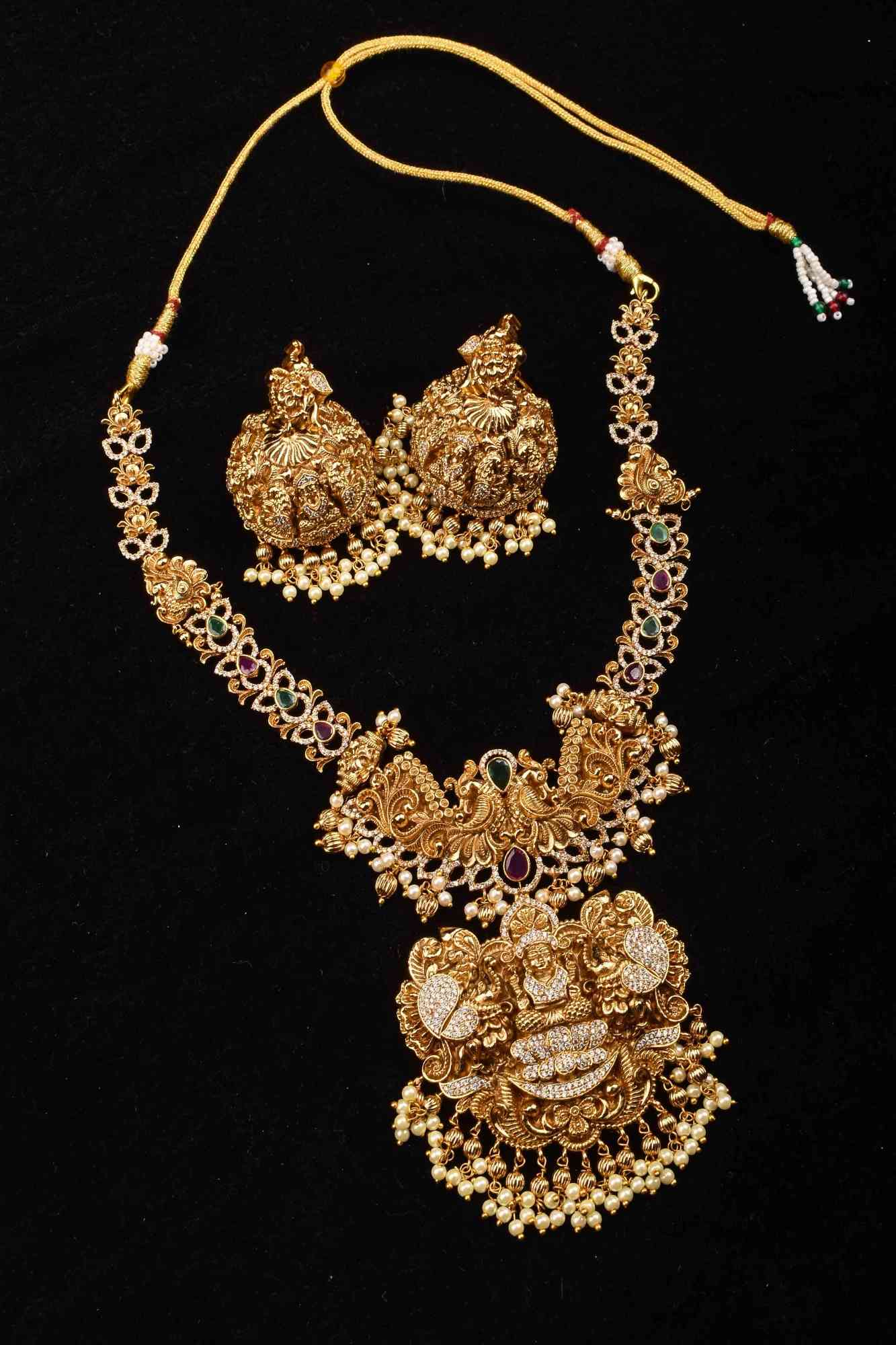 Stunning Antique Gold Finish Temple Necklace Set with Goddess Lakshmi Pendant and Pearl Embellishments
