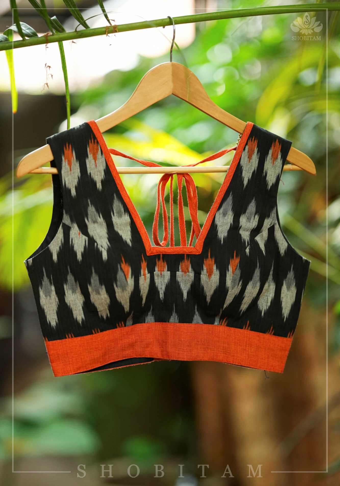 Black and orange cotton Ikkat square neck sleeveless blouse with orange handloom border.