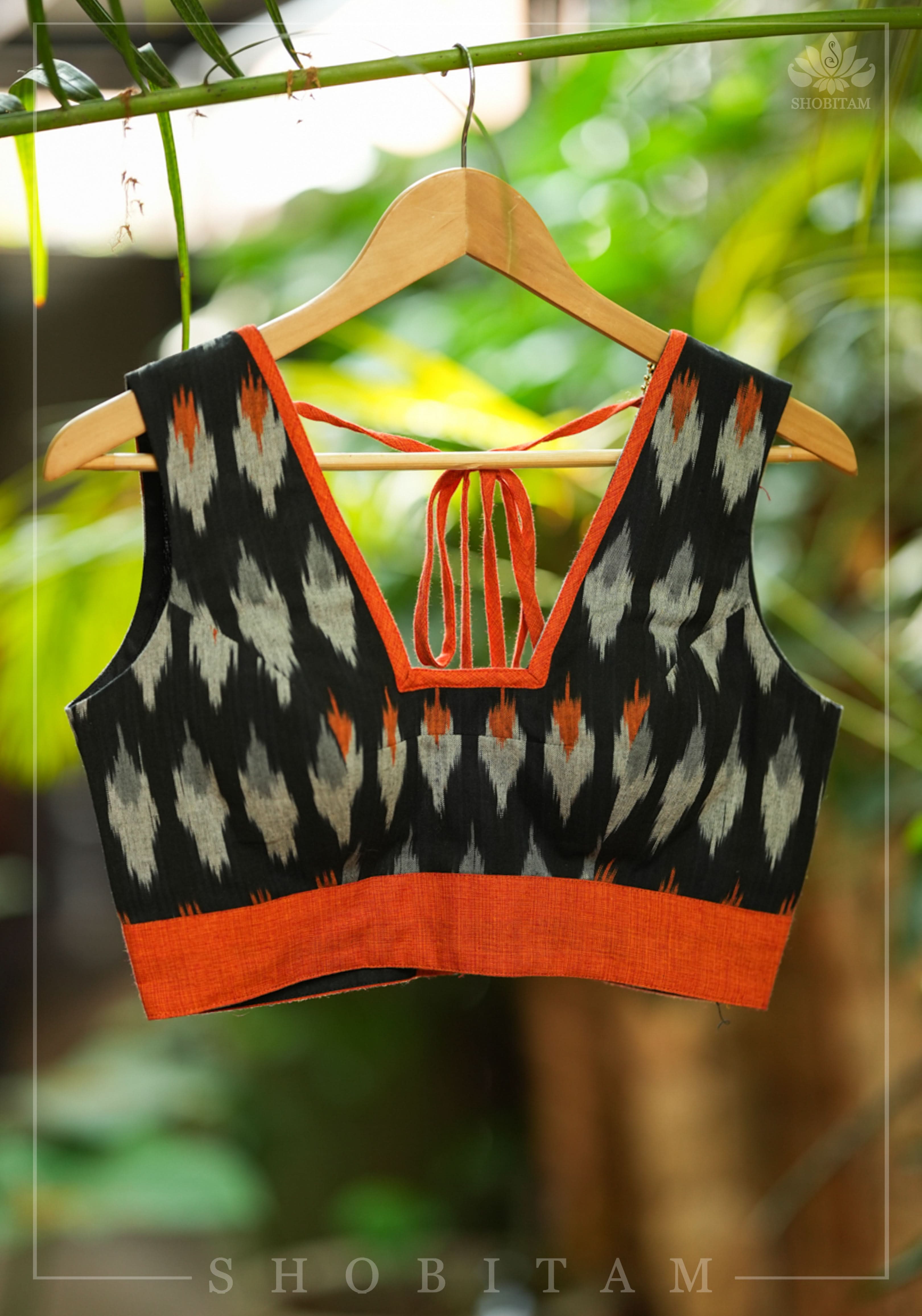 Black and orange cotton Ikkat square neck sleeveless blouse with orange handloom border. | Shobitam