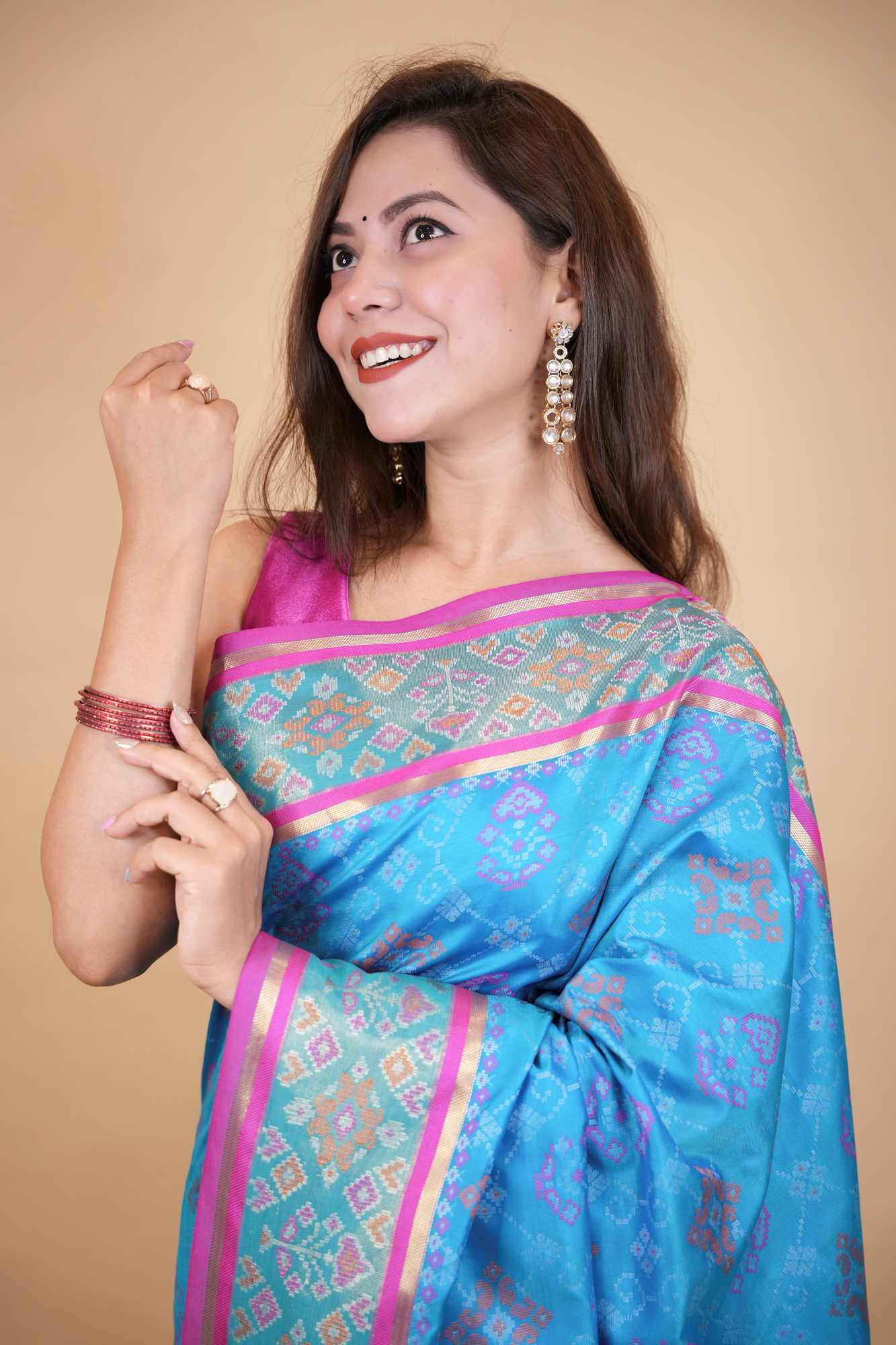 Firozi Patola weave and zari interwoven with resham border tassels i pallu prestitched saree