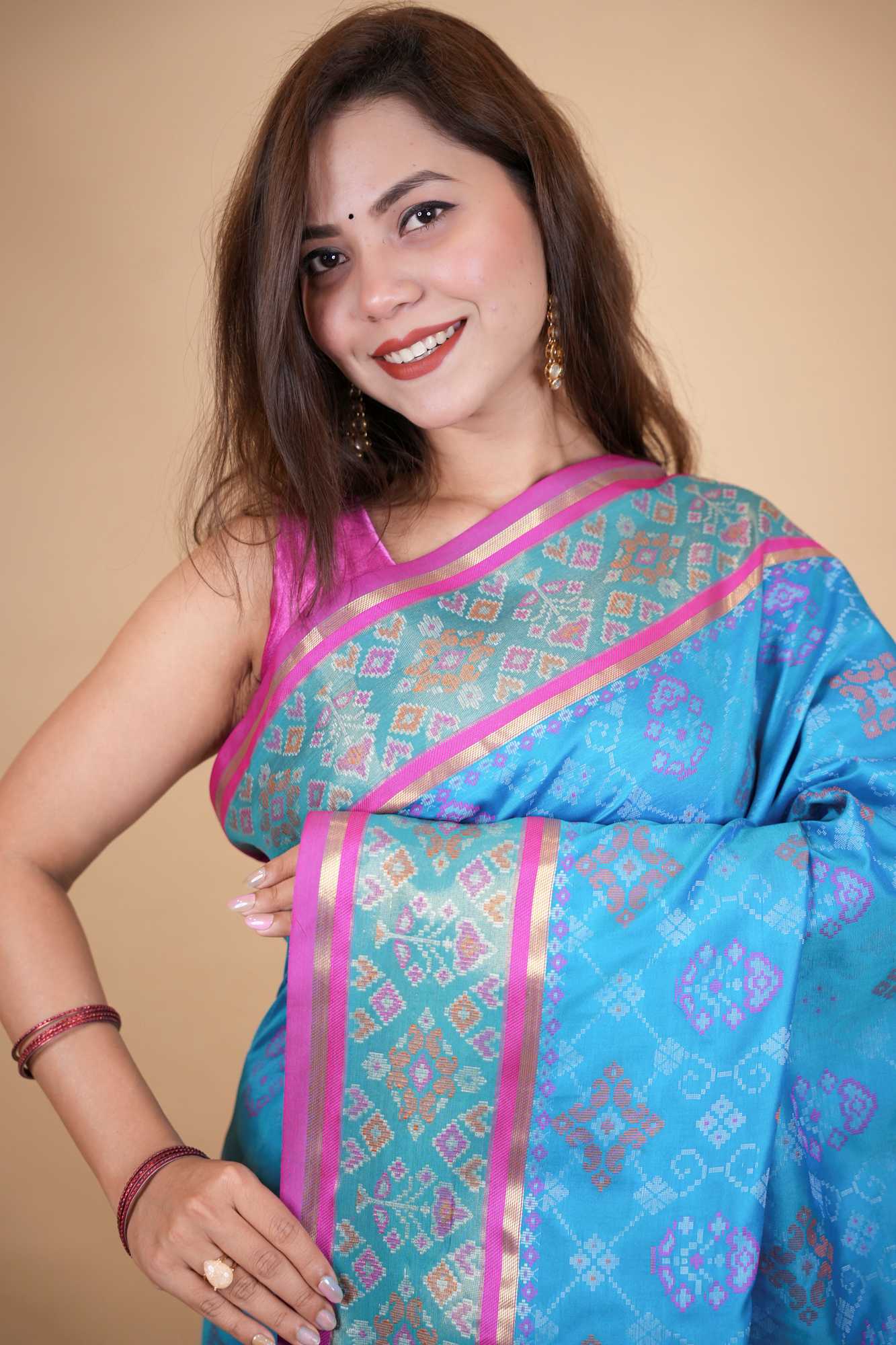 Firozi Patola weave and zari interwoven with resham border tassels i pallu prestitched saree