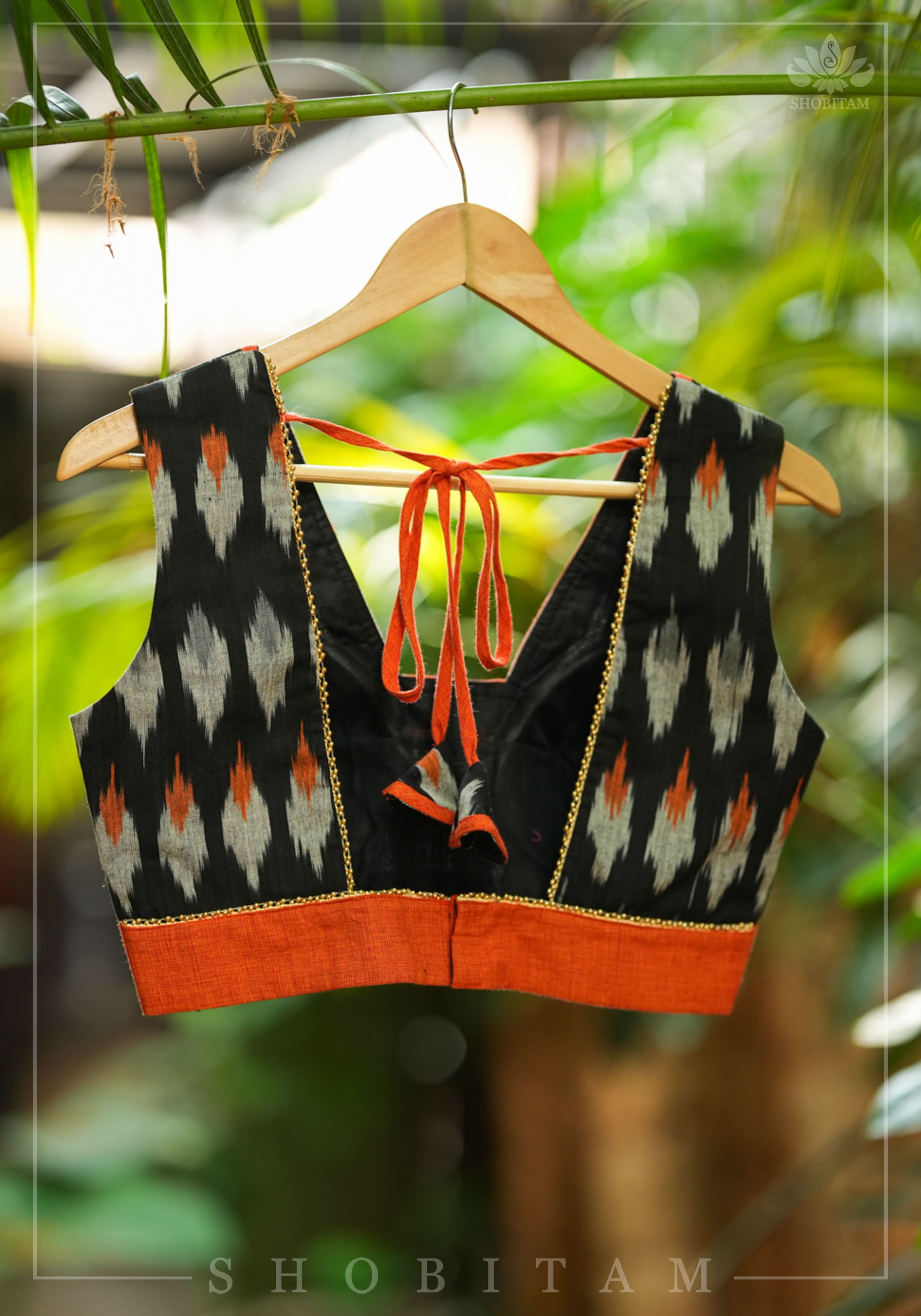 Black and orange cotton Ikkat square neck sleeveless blouse with orange handloom border. | Shobitam