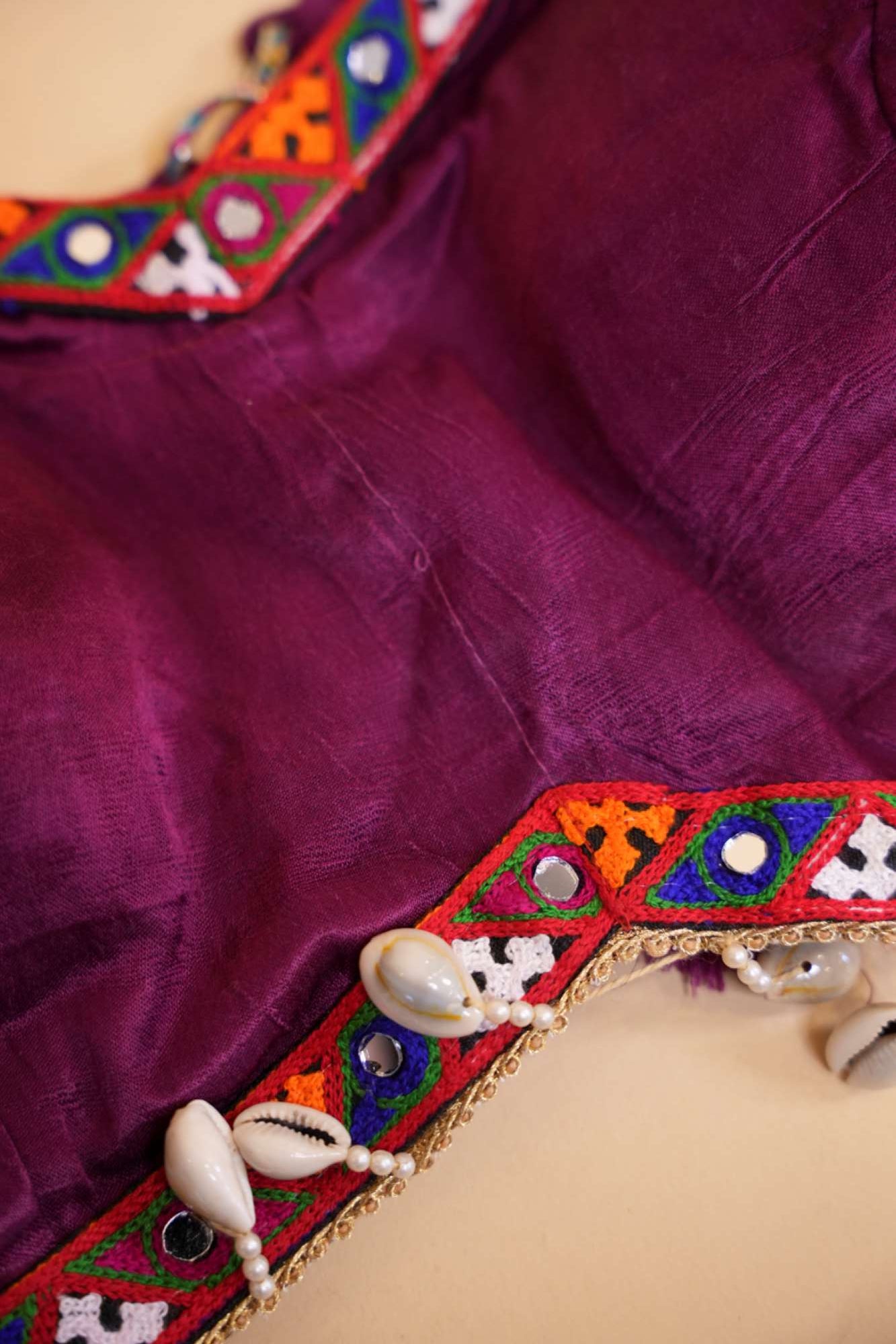 Stylish Navratri-Inspired Purple Blouse with Multicolor Embroidered Border & Cowrie Shell Accents