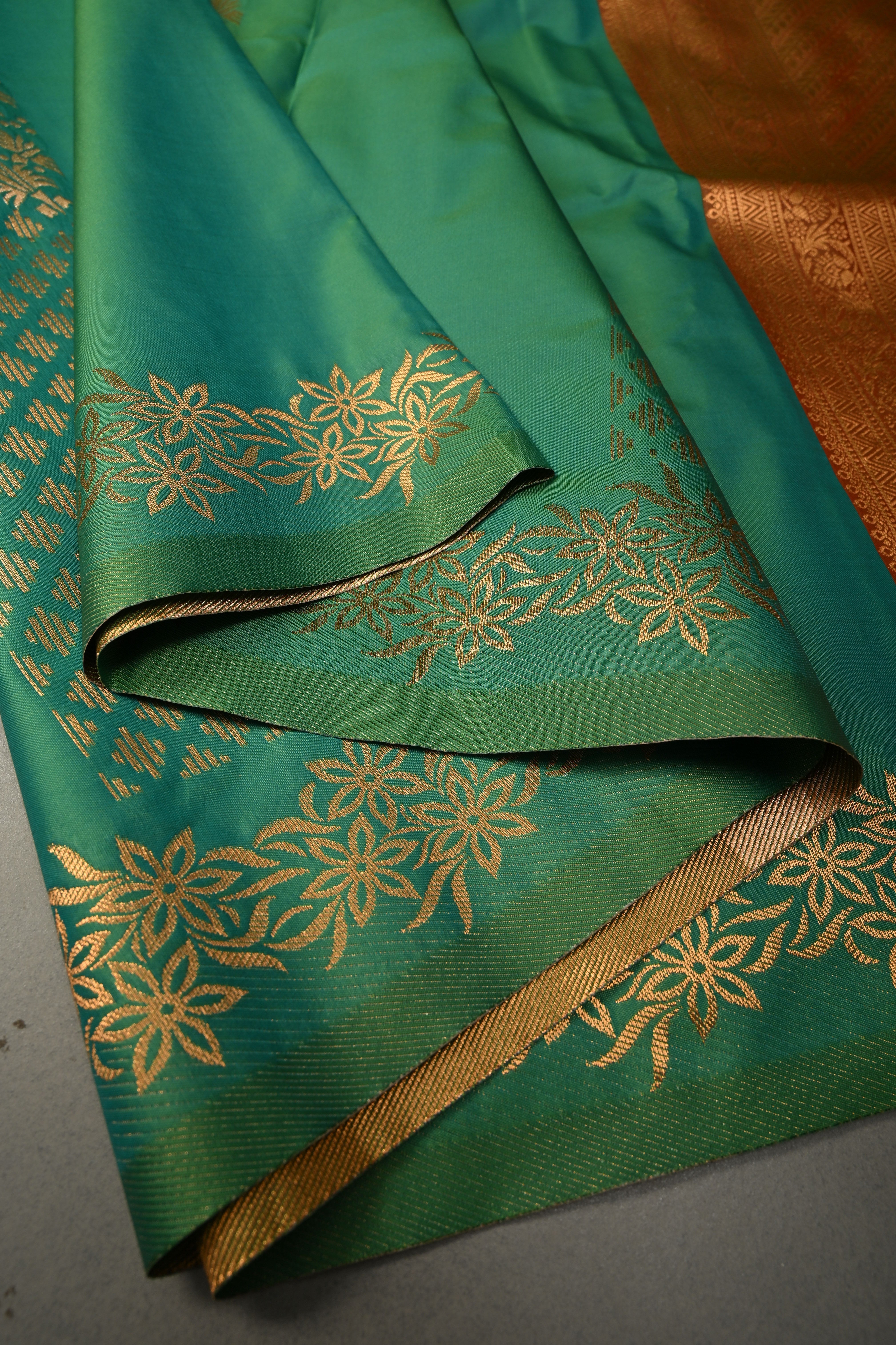 Green Kanchi Semi Silk Saree with Floral Zari Buttas and Gold-Silver Motifs on Border | Shobitam