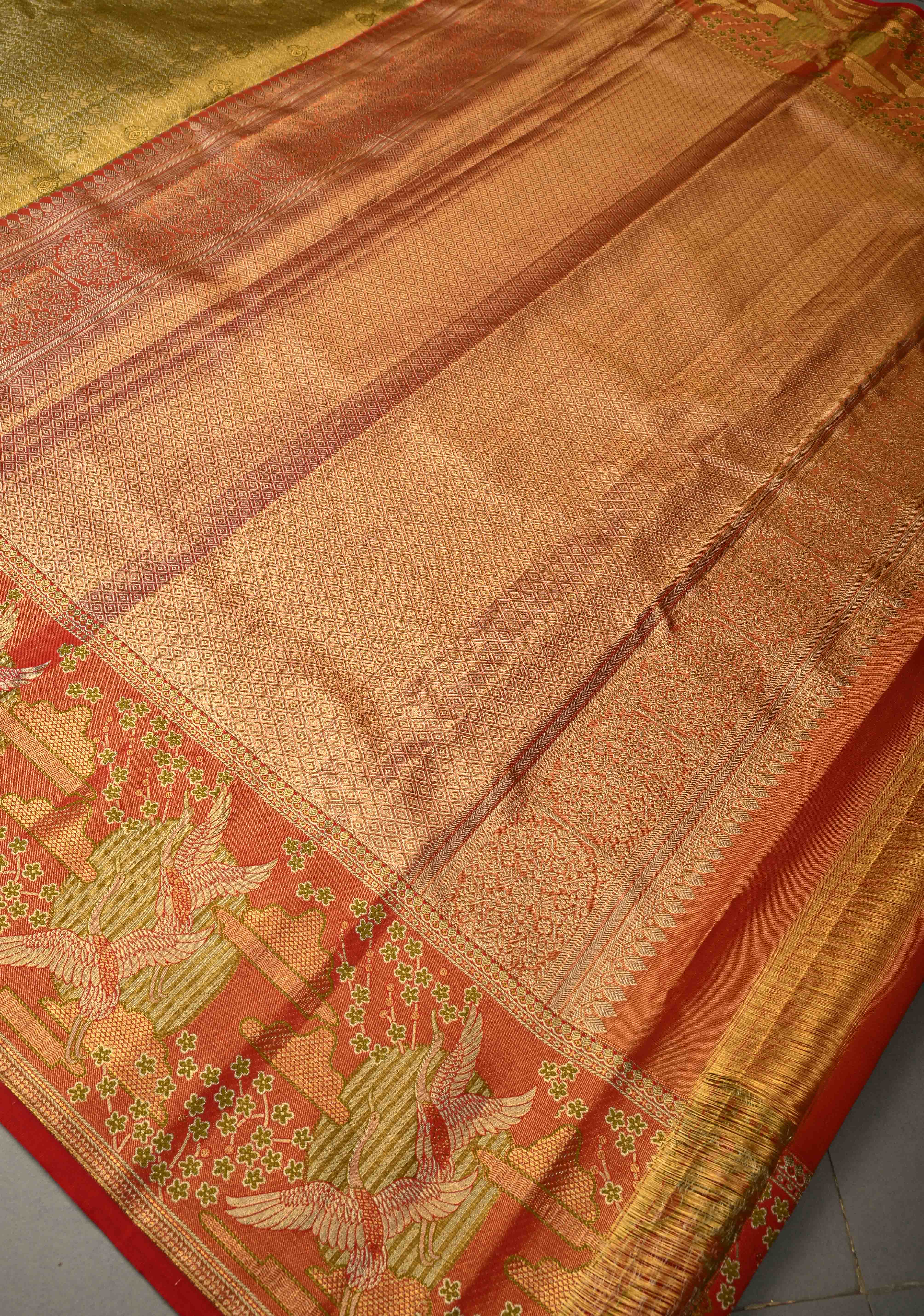 Ollive Green Kanjivaram Tissue Semi Silk Saree with Meenakari Floral Brocade Jaal and Contrast Zari Border | Shobitam