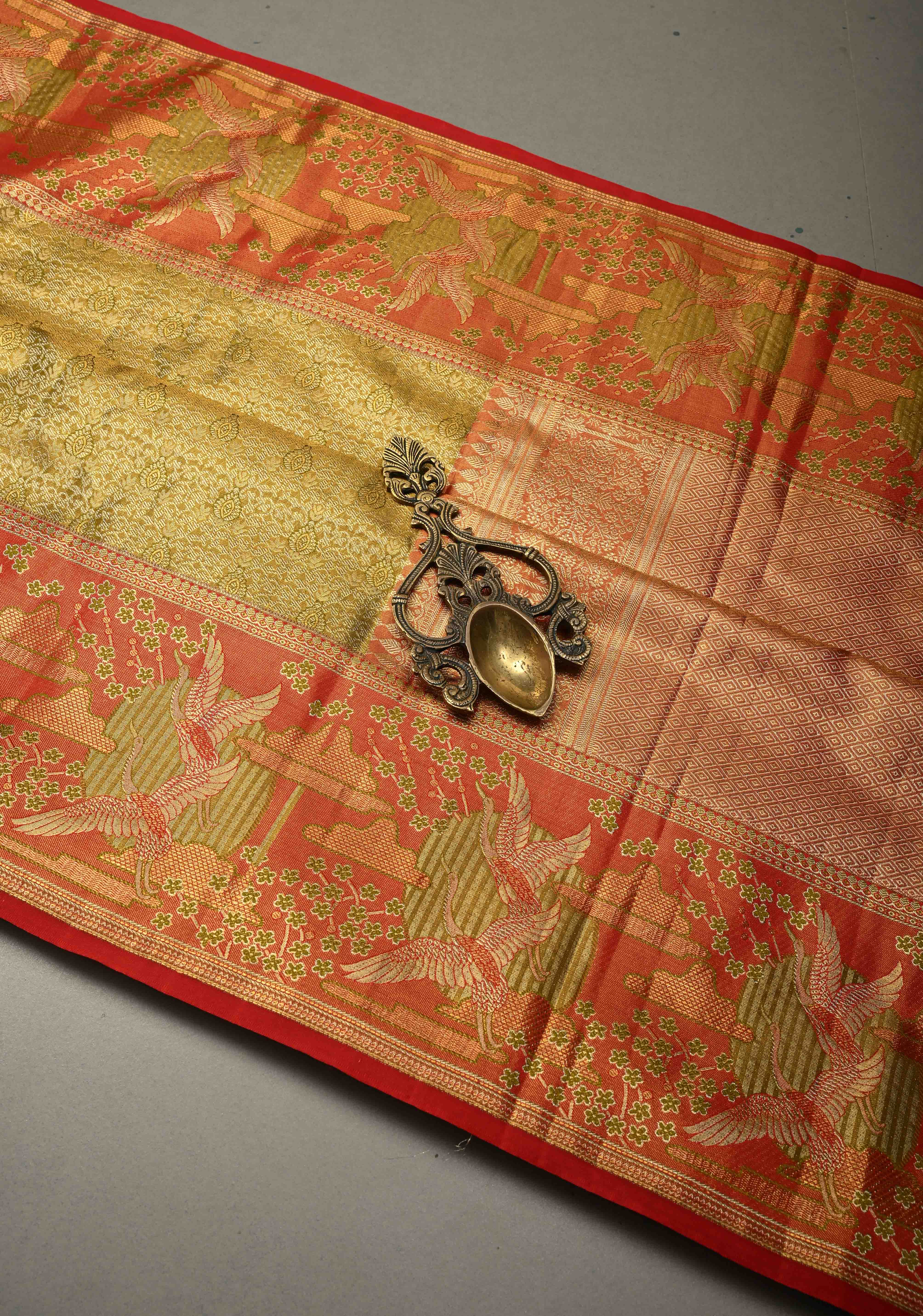 Ollive Green Kanjivaram Tissue Semi Silk Saree with Meenakari Floral Brocade Jaal and Contrast Zari Border | Shobitam