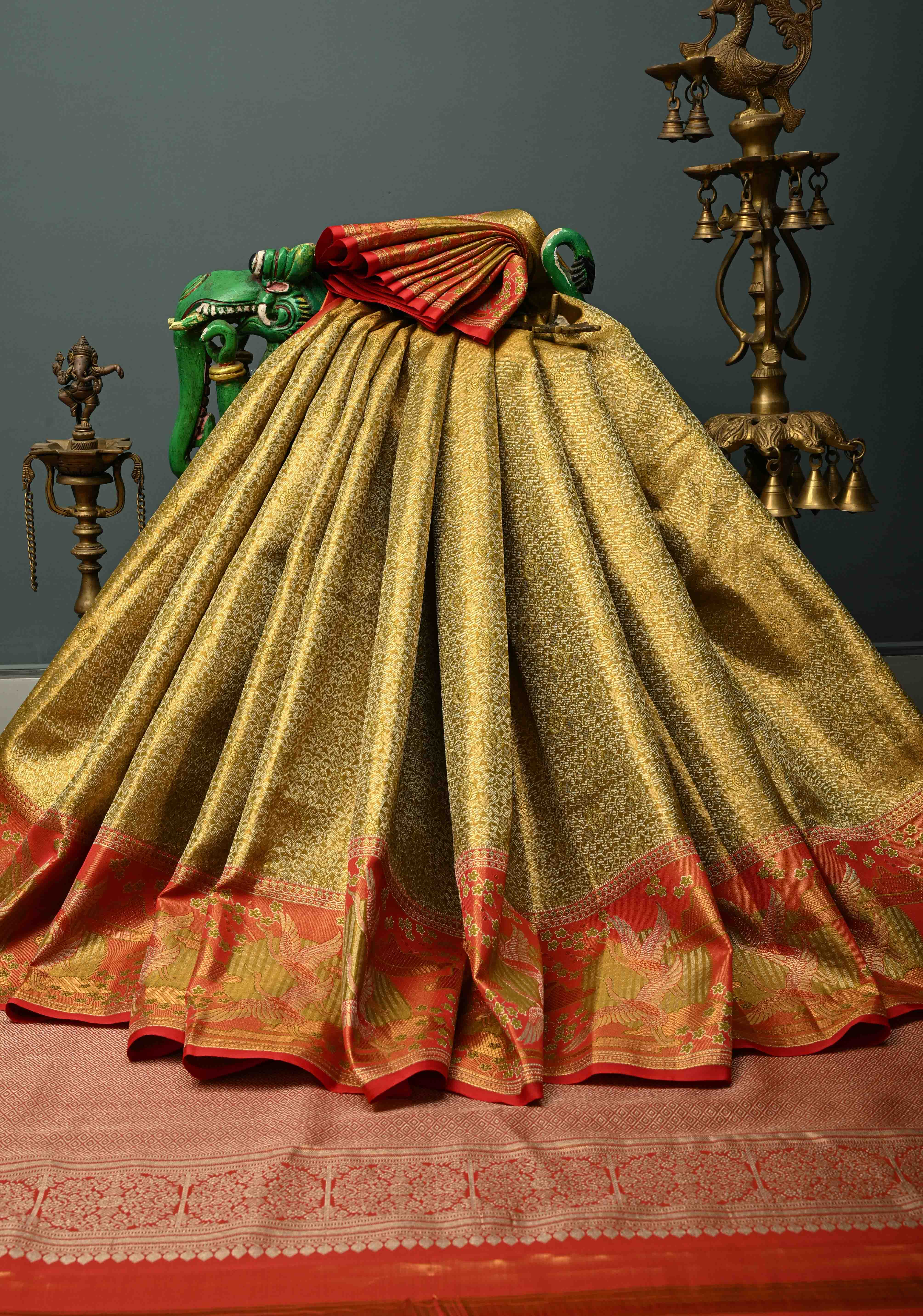 Ollive Green Kanjivaram Tissue Semi Silk Saree with Meenakari Floral Brocade Jaal and Contrast Zari Border | Shobitam