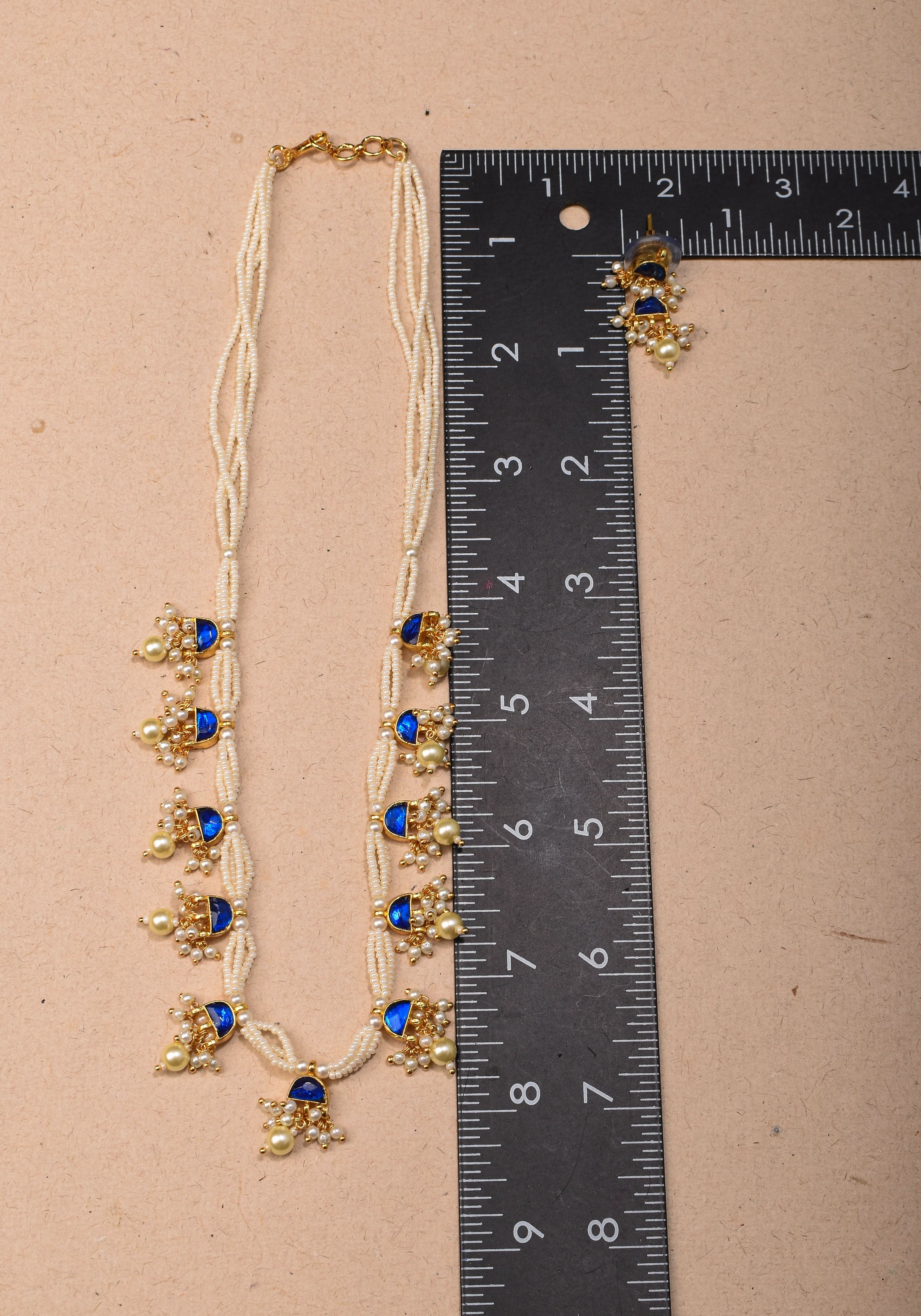 Lightweight Jadau Necklace Set with eleven dangling royal blue stones and matching earrings | Shobitam Jewelry