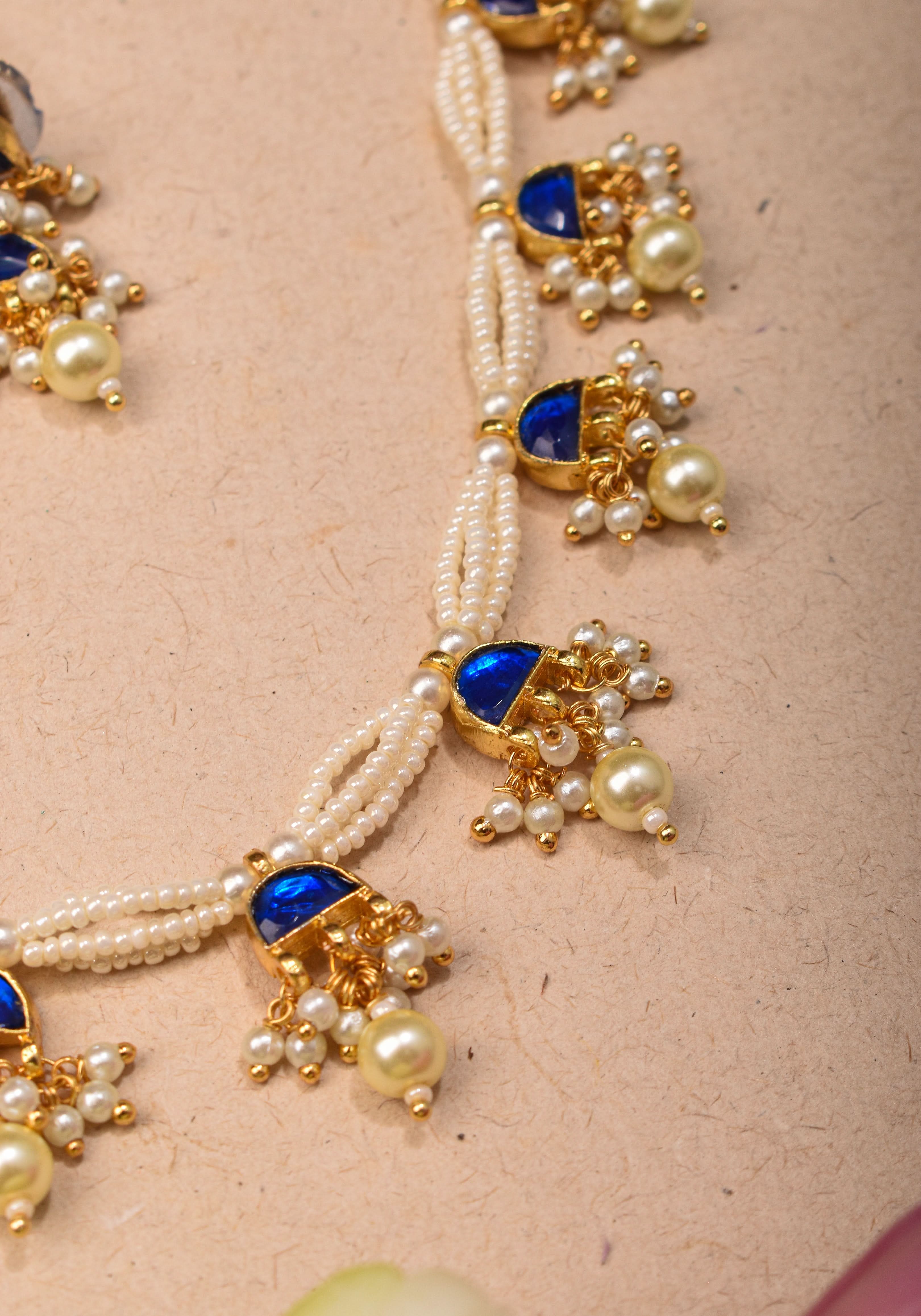 Lightweight Jadau Necklace Set with eleven dangling royal blue stones and matching earrings | Shobitam Jewelry
