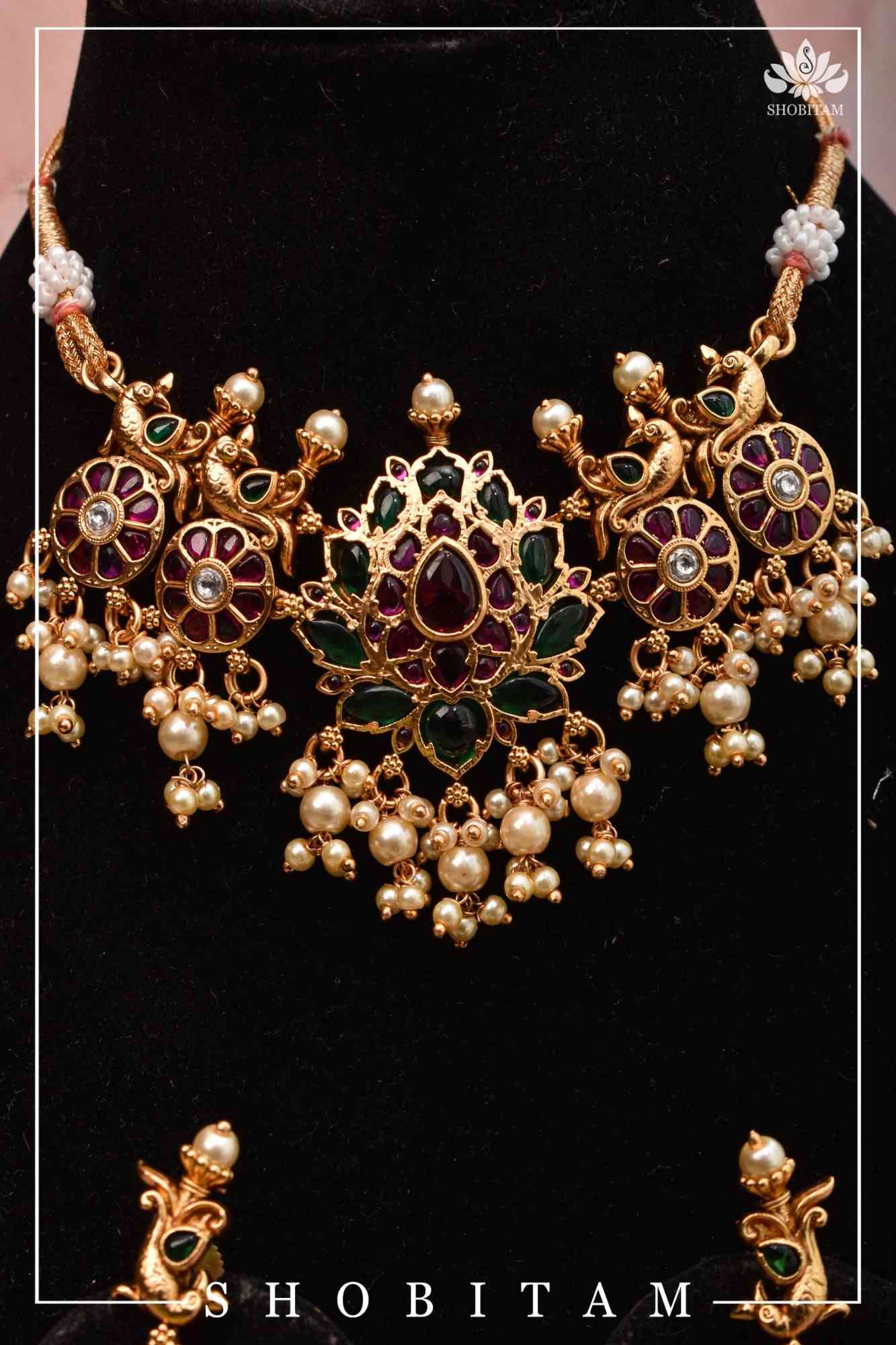 Jadau Lotus Stone Embellishment with Peacock units Choker Set In Green,Pink and white With Matching Earrings