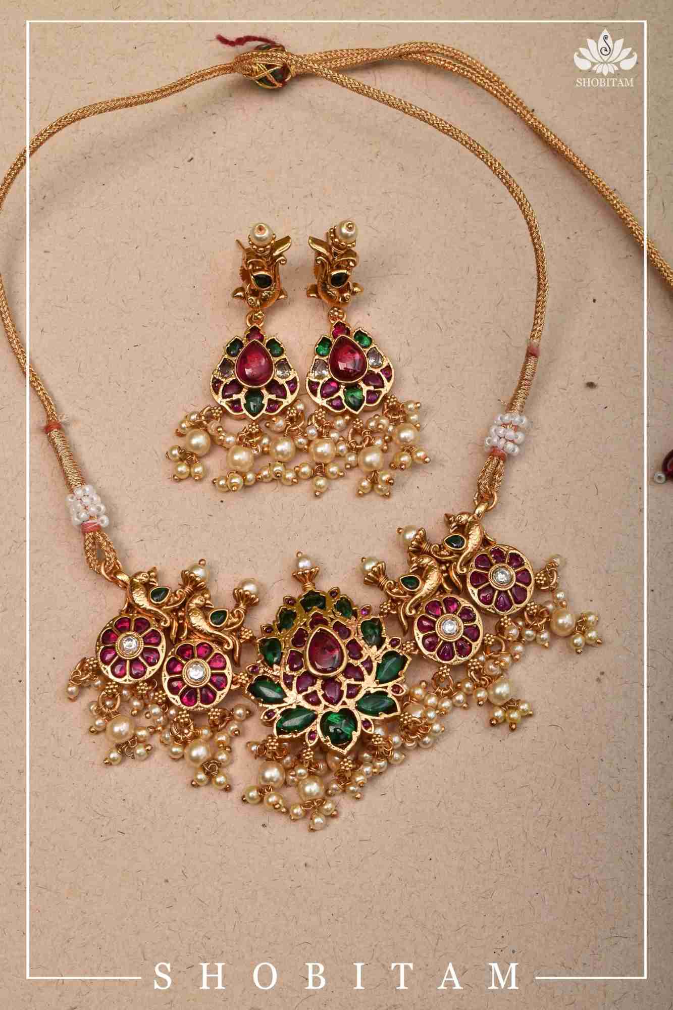 Jadau Lotus Stone Embellishment with Peacock units Choker Set In Green,Pink and white With Matching Earrings