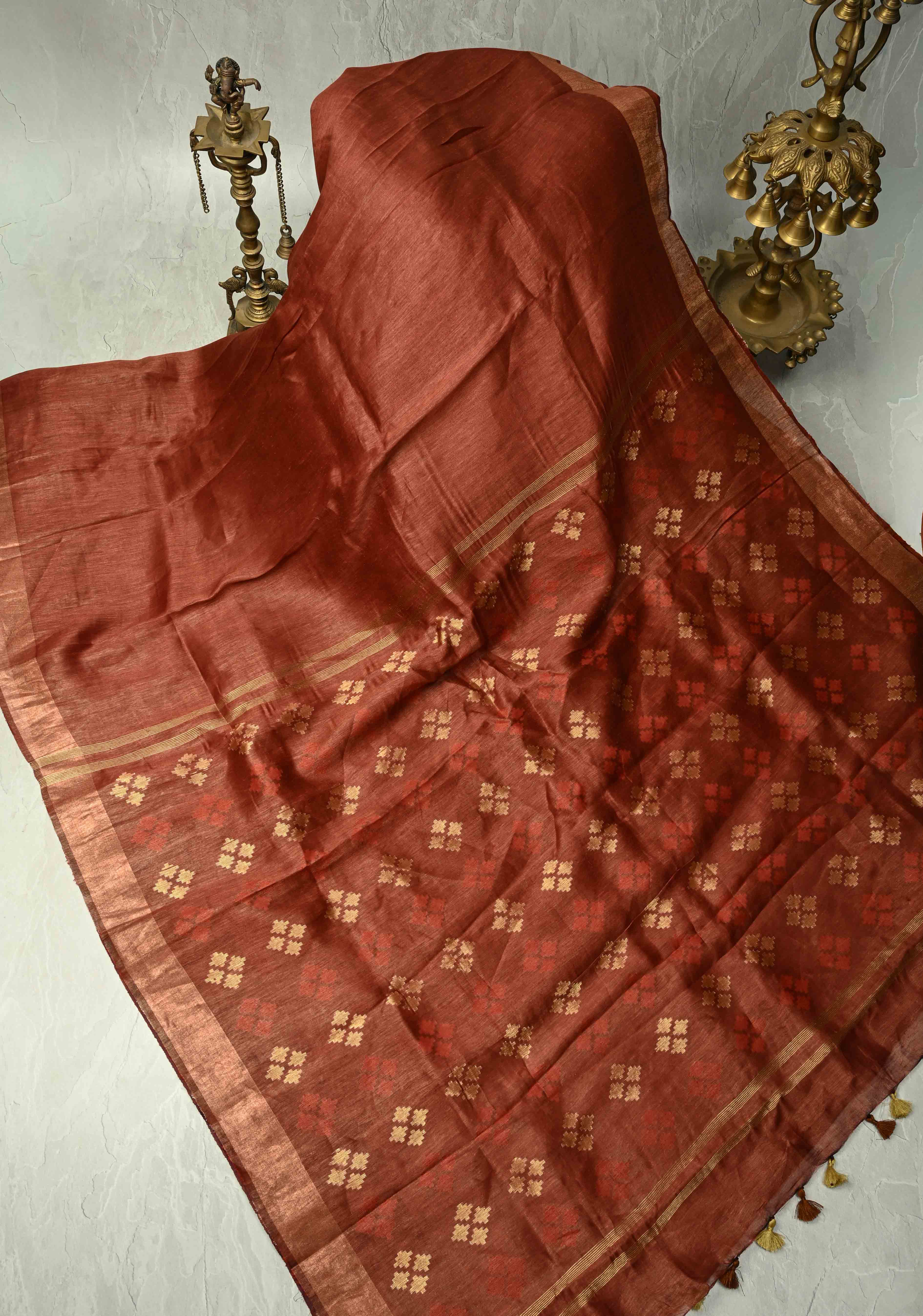 Copper Rust Silk Linen Saree with Muted Tissue Border and Floral Buttas on Pallu | Shobitam