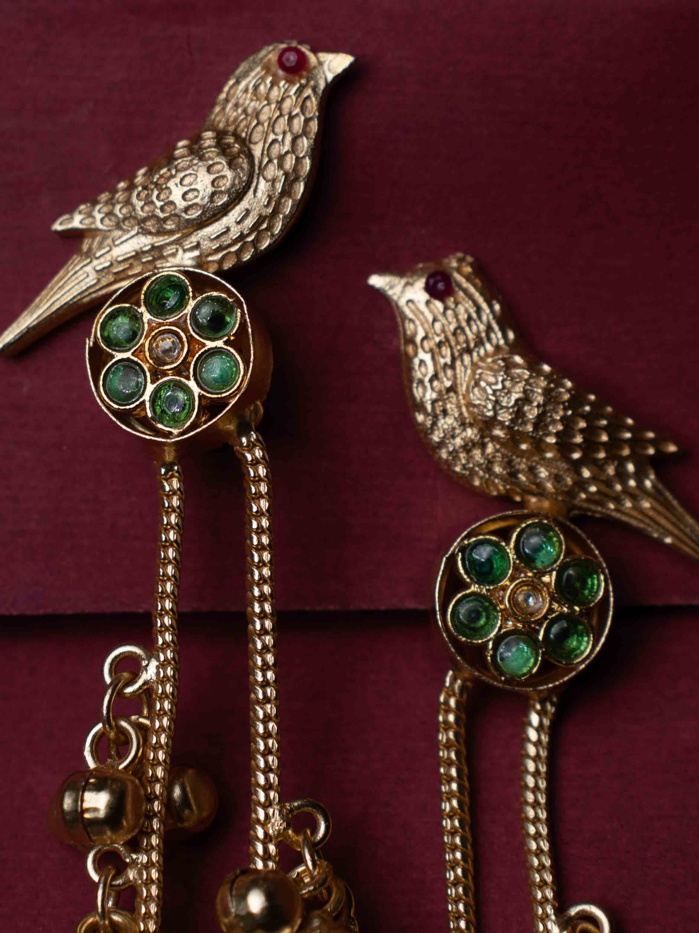 Gold Plated Bird Motif Long Jhumka Earrings with Pearl Drops & Green Stone Accents