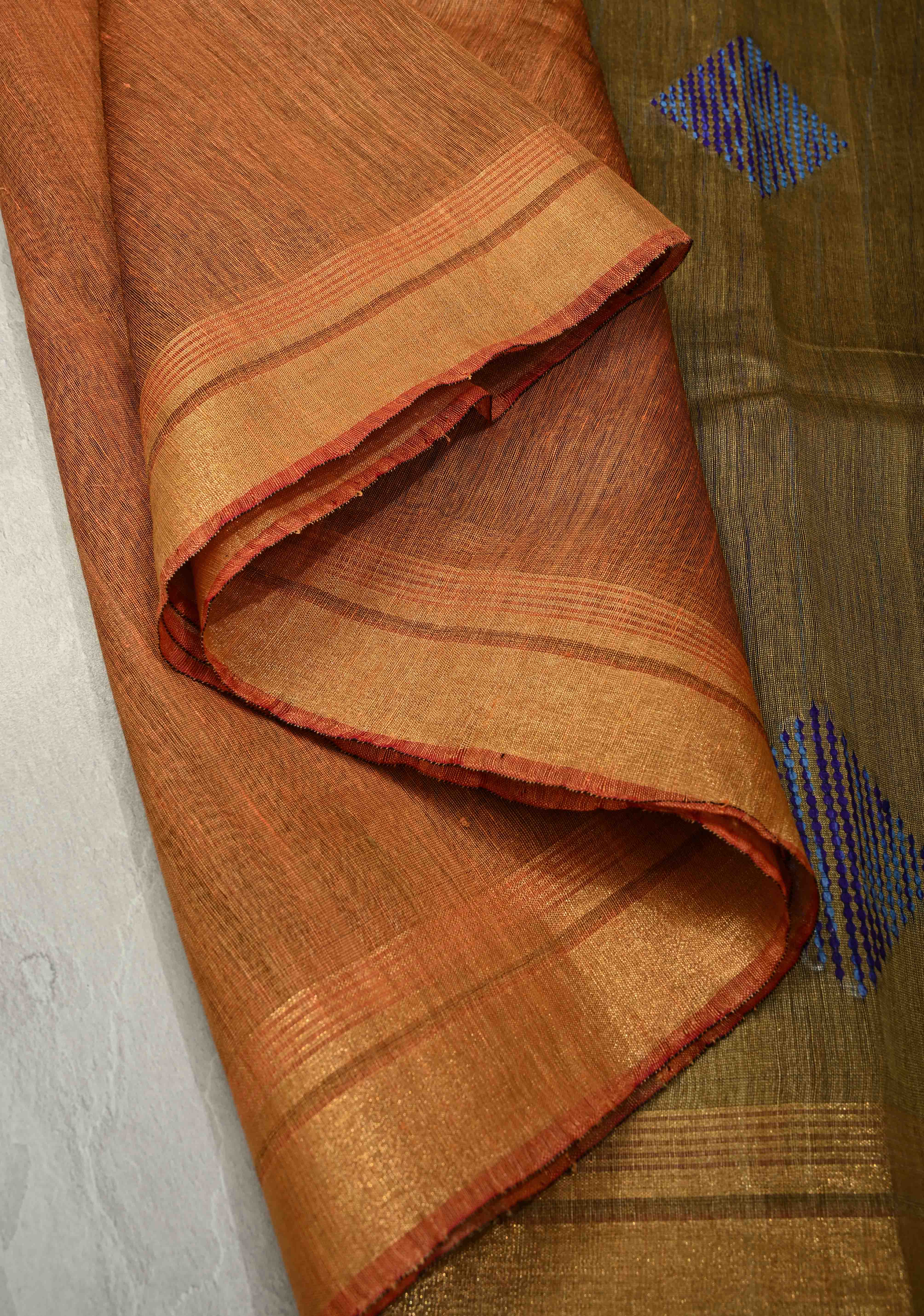 Rust Orange Handwoven Silk Linen Saree with Thread Buttas and Muted Zari Border | Shobitam