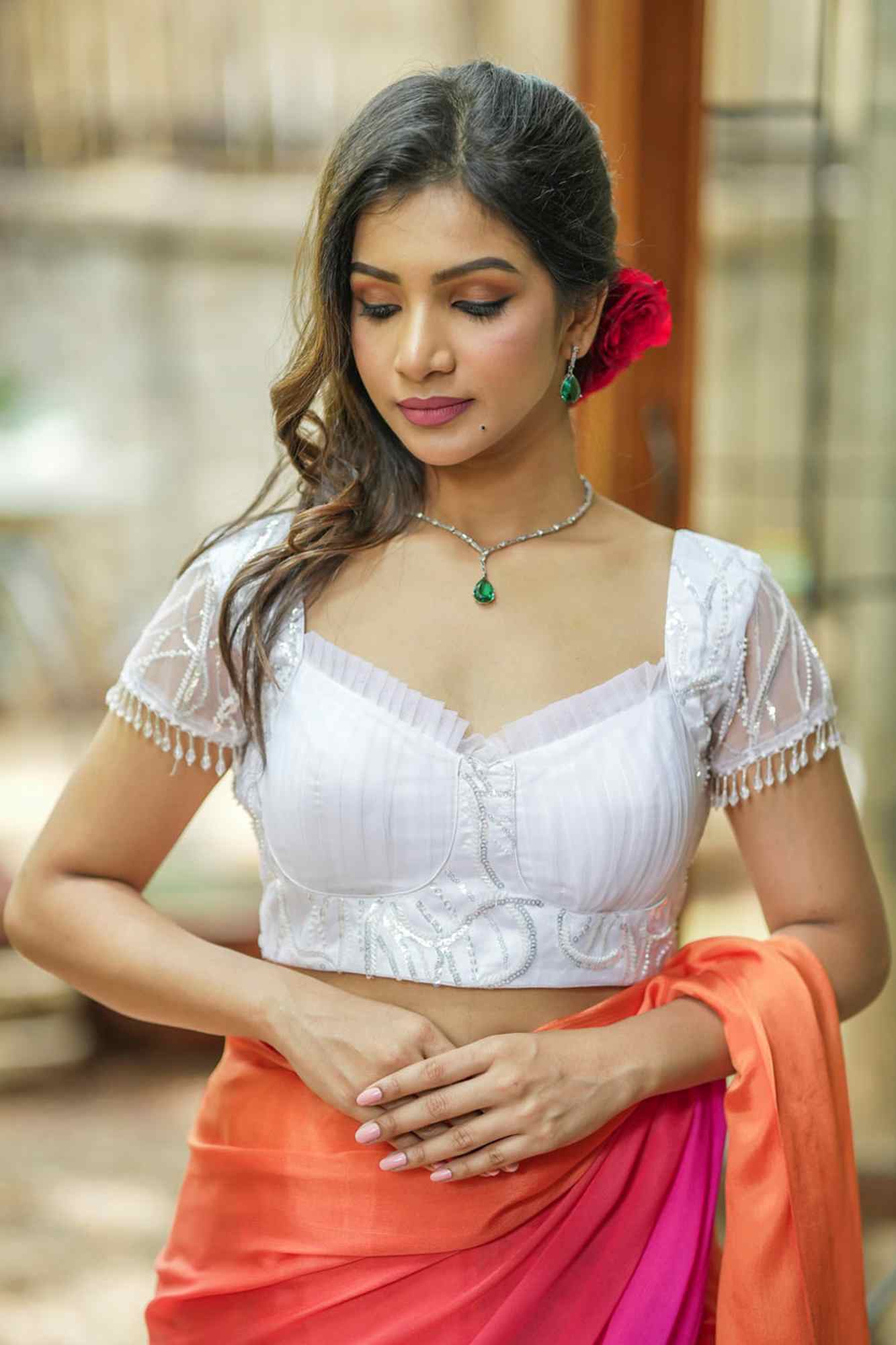 White sequin sweetheart neck blouse with net frills detailing.