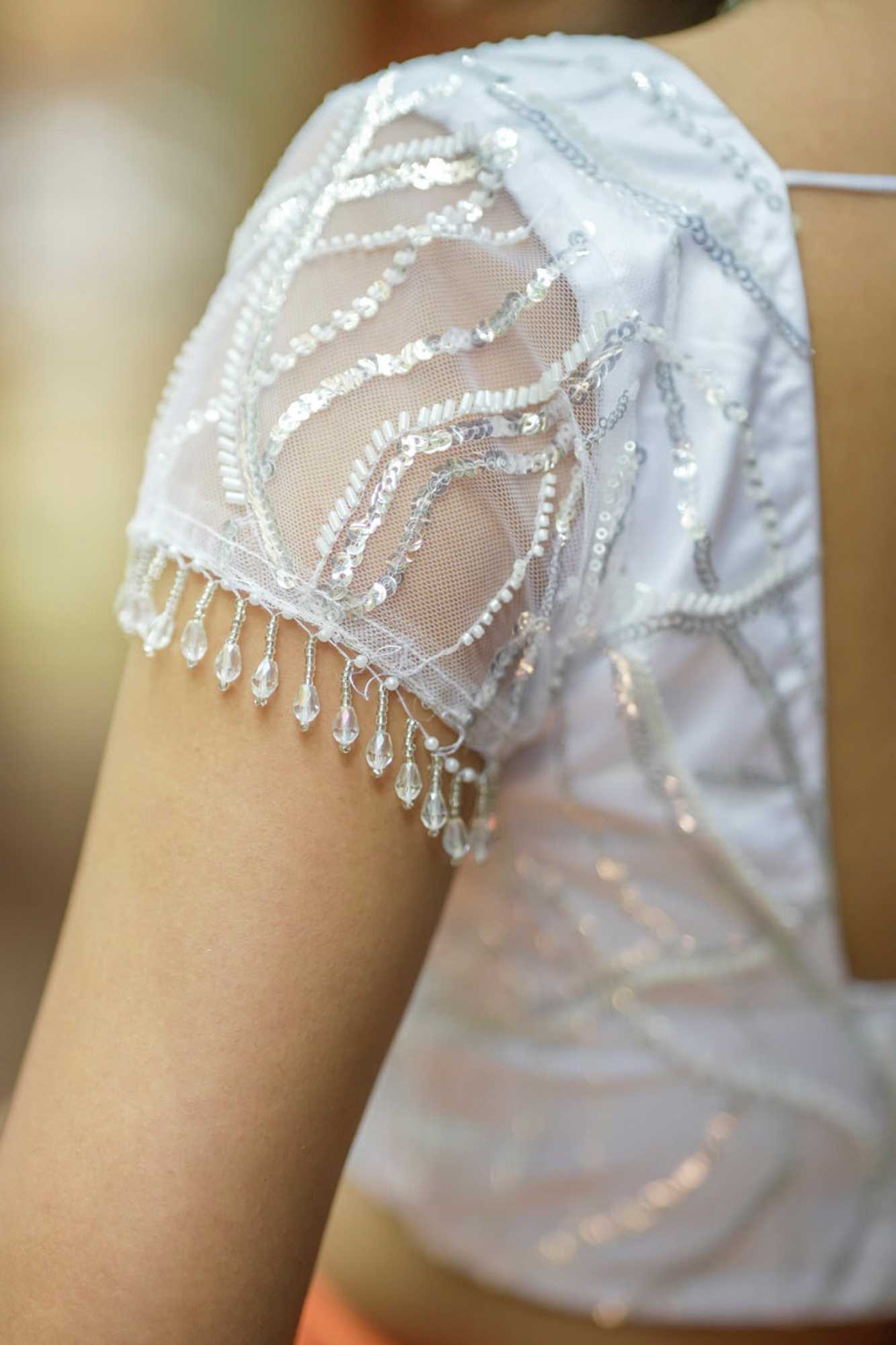 White sequin sweetheart neck blouse with net frills detailing.