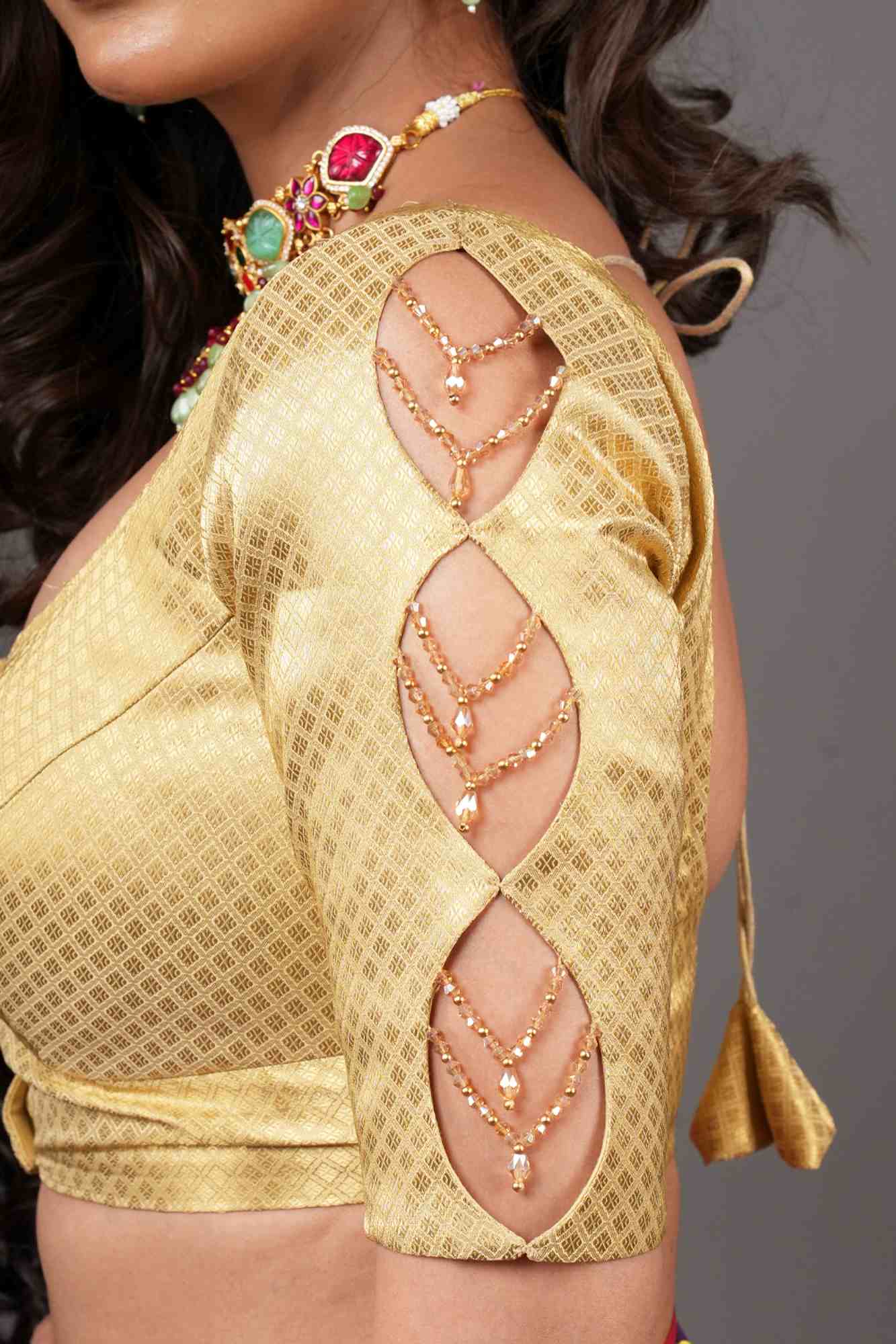 Gold brocade U neck blouse with cutout and crystal detailing in sleeves.