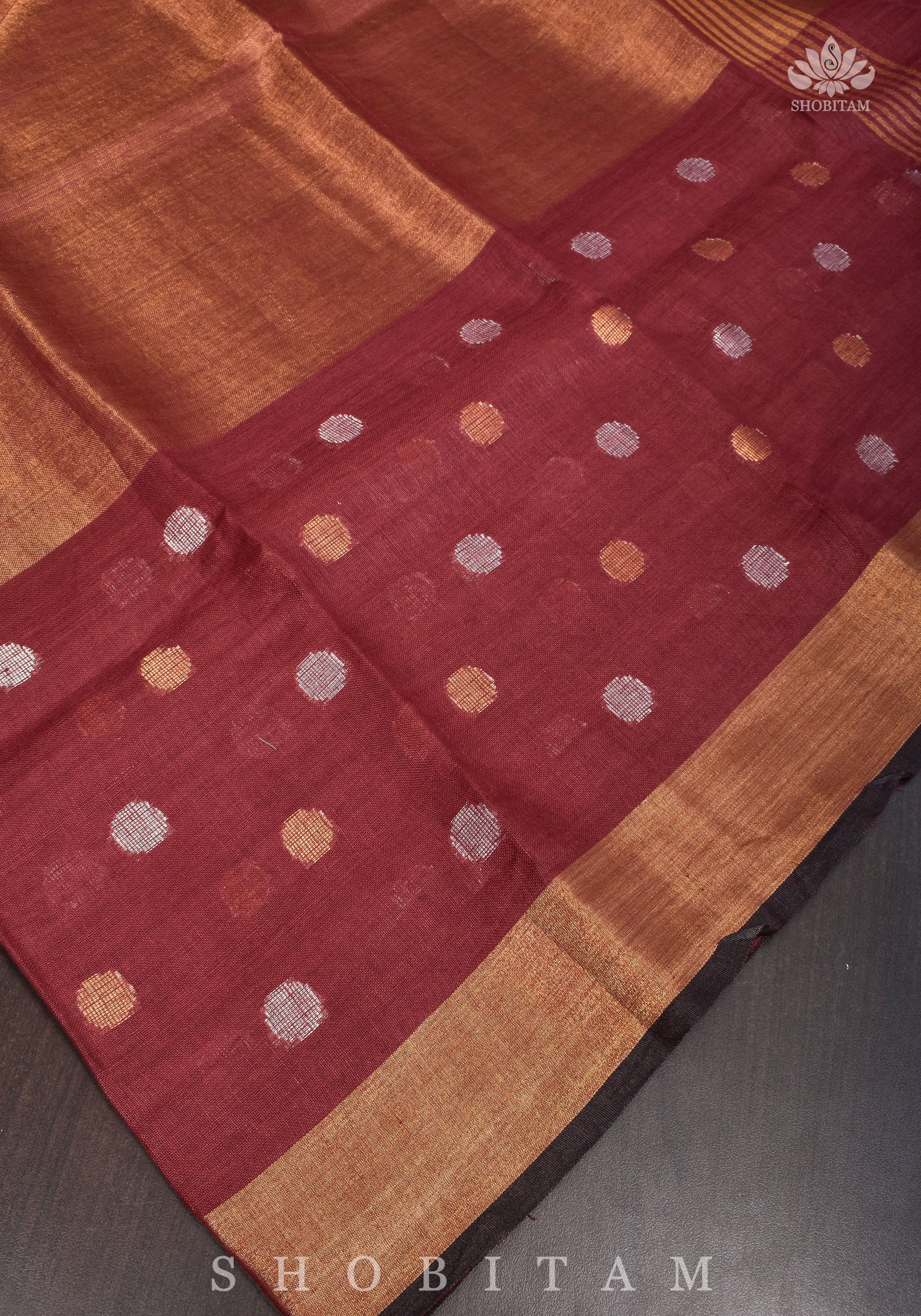 Maroon Tissue Body Linen Saree in Muted Antique Gold with Sona Rupa Polka Dots Skirt Border | Shobitam