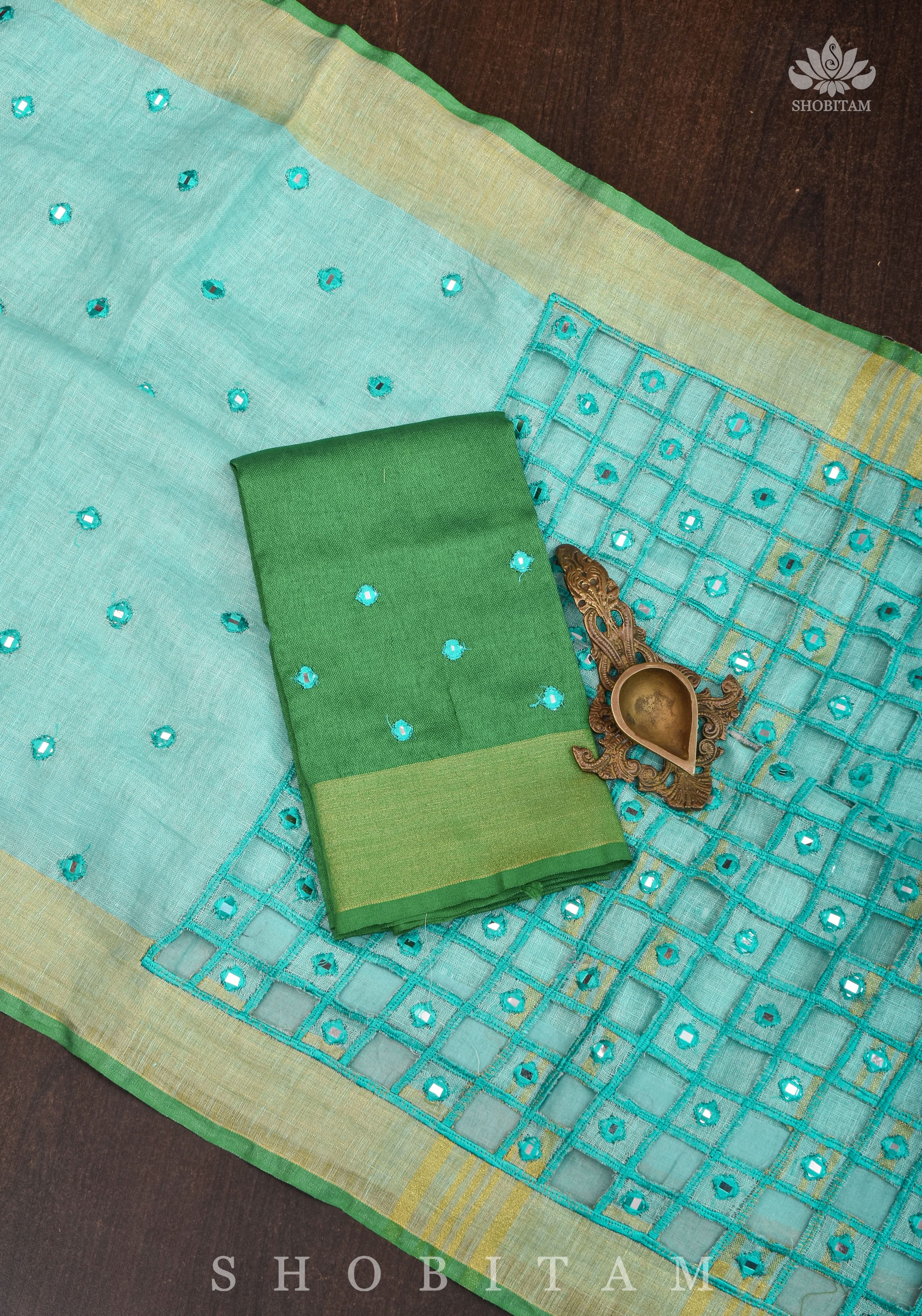 Jaali Pallu - Cutwork and Mirrorwork Saree in Linen by Linen in Teal Color | Shobitam