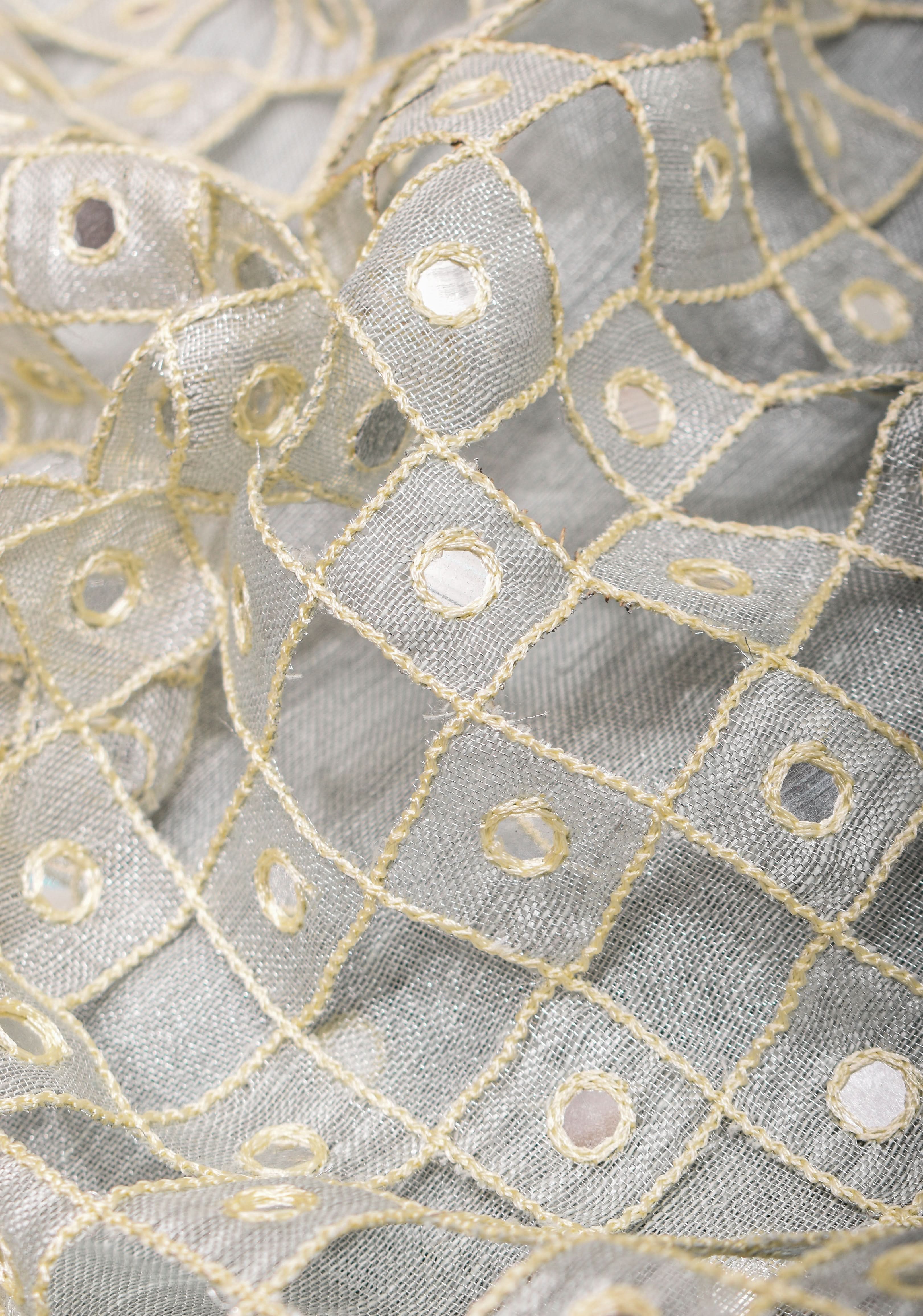 Cutwork and Mirror Work Tissue Linen Saree in White Silver with dramatic tassels | Shobitam