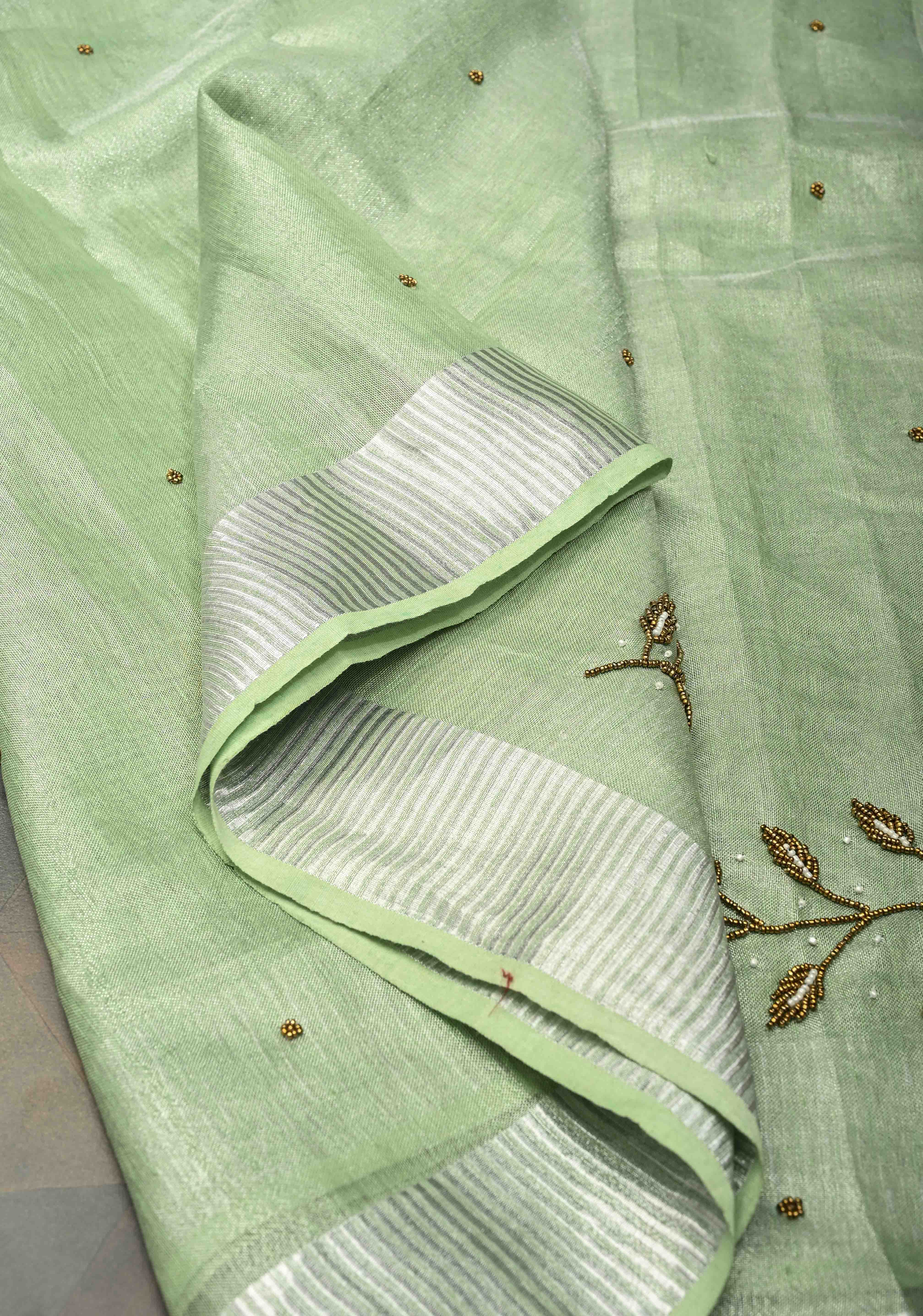 Hand Beadwork and Embroidery on Tissue Linen Saree in Sage Green and silver | Shobitam