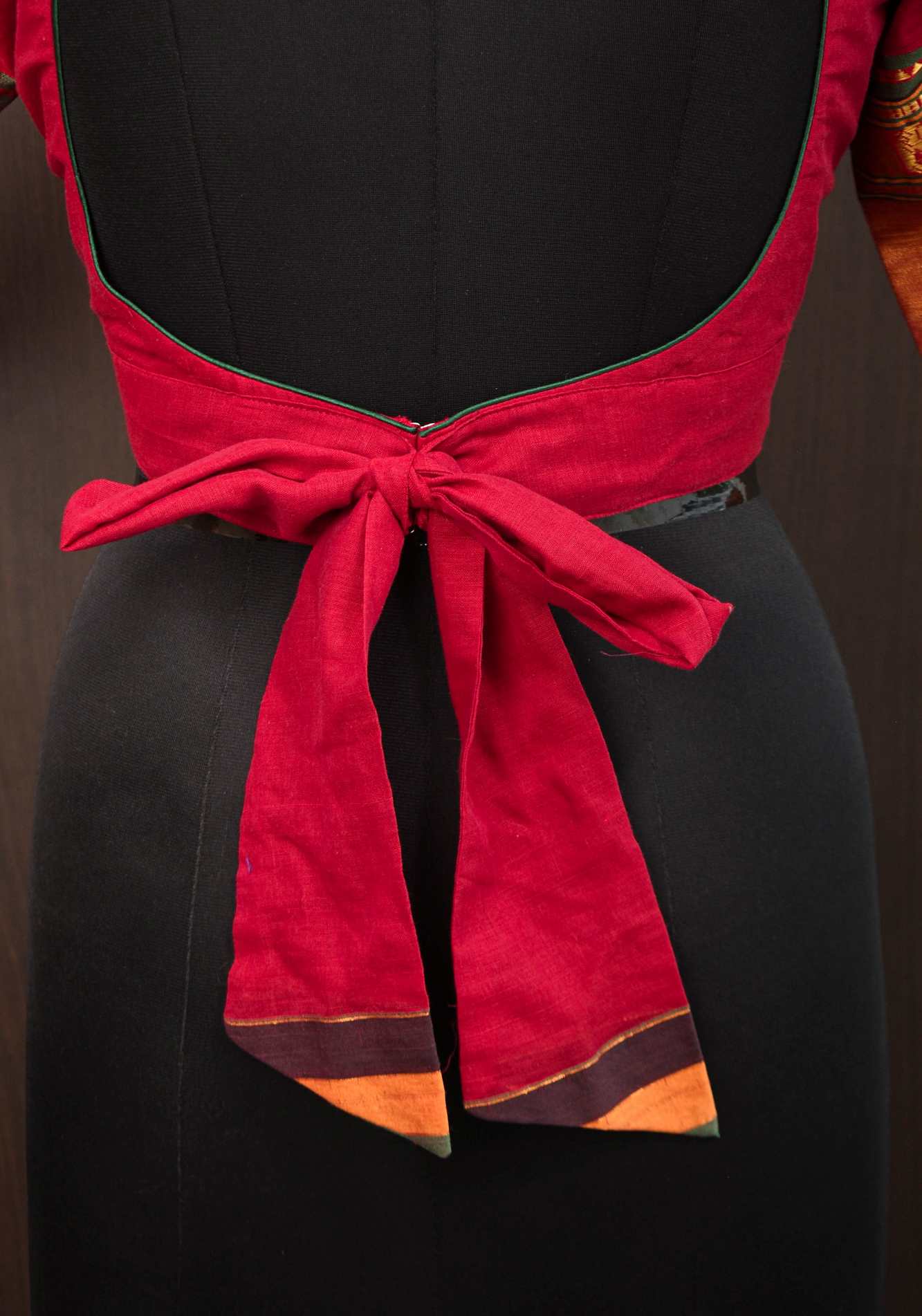 Maroon Narayanpet cotton boatneck blouse with oval cutout and tieback design