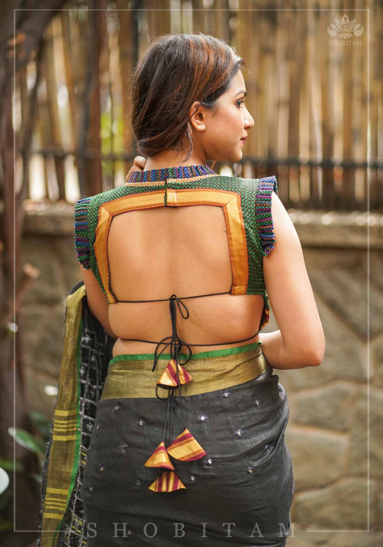 Dark green & black khana silk V neck blouse with frill detailing and backless design< made to order