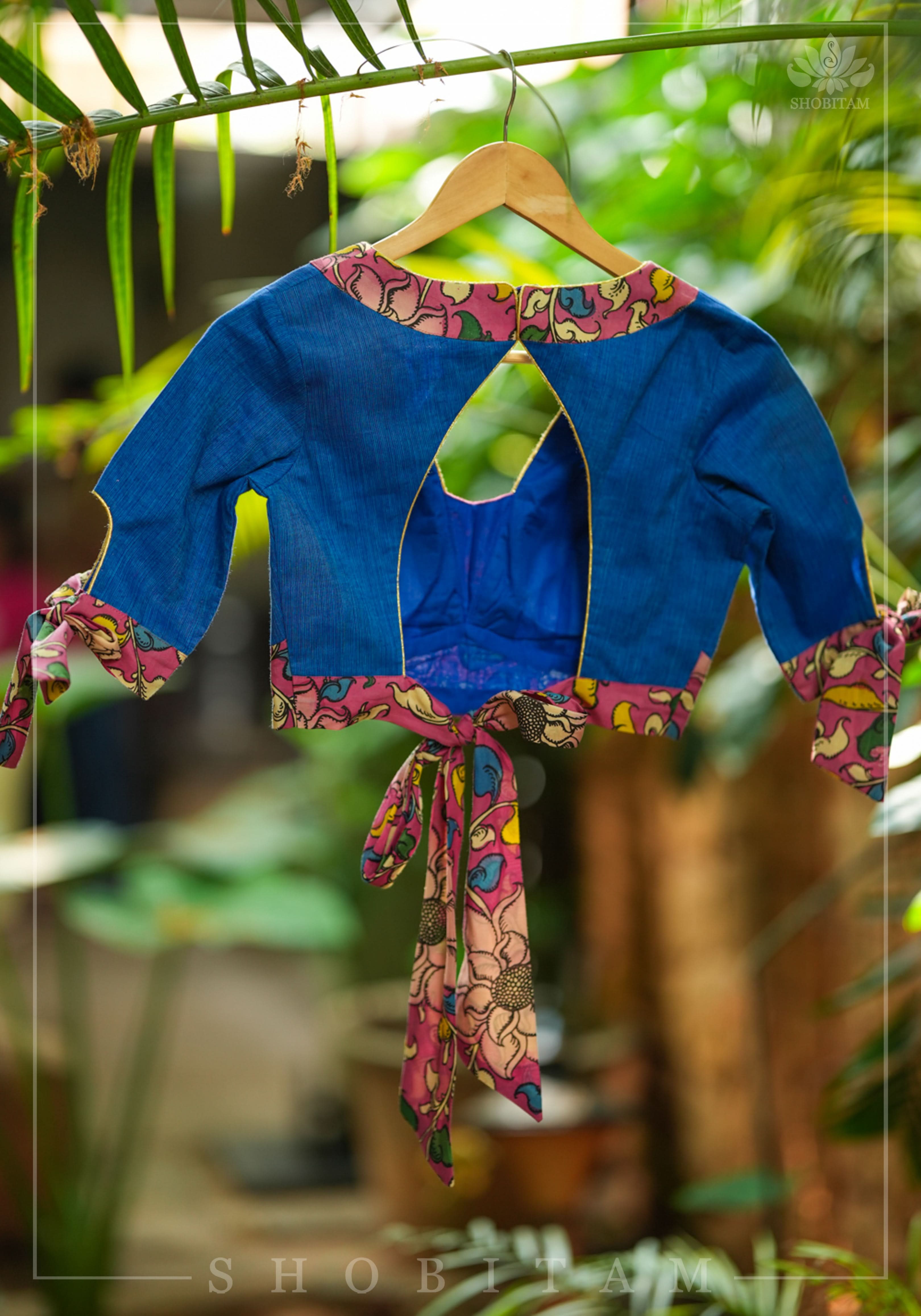 Ocean blue handloom V neck blouse with rose pink handpainted kalamkari border detailing. | Shobitam