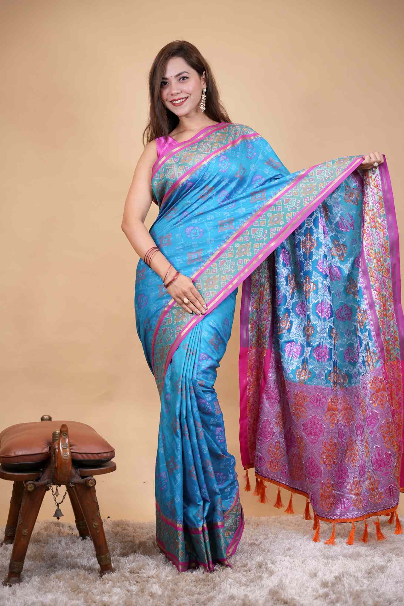 Firozi Patola weave and zari interwoven with resham border tassels i pallu prestitched saree