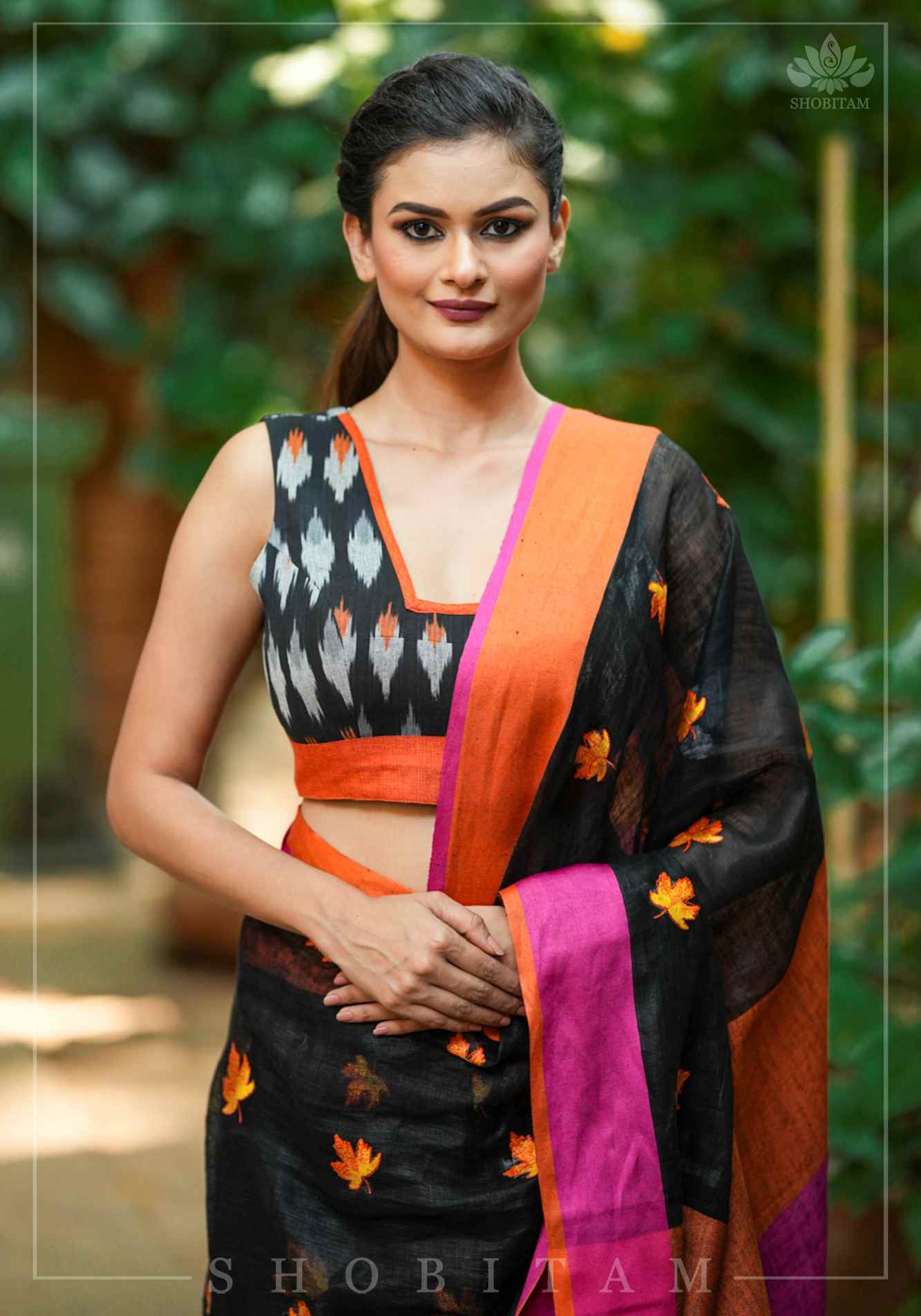 Black and orange cotton Ikkat square neck sleeveless blouse with orange handloom border.