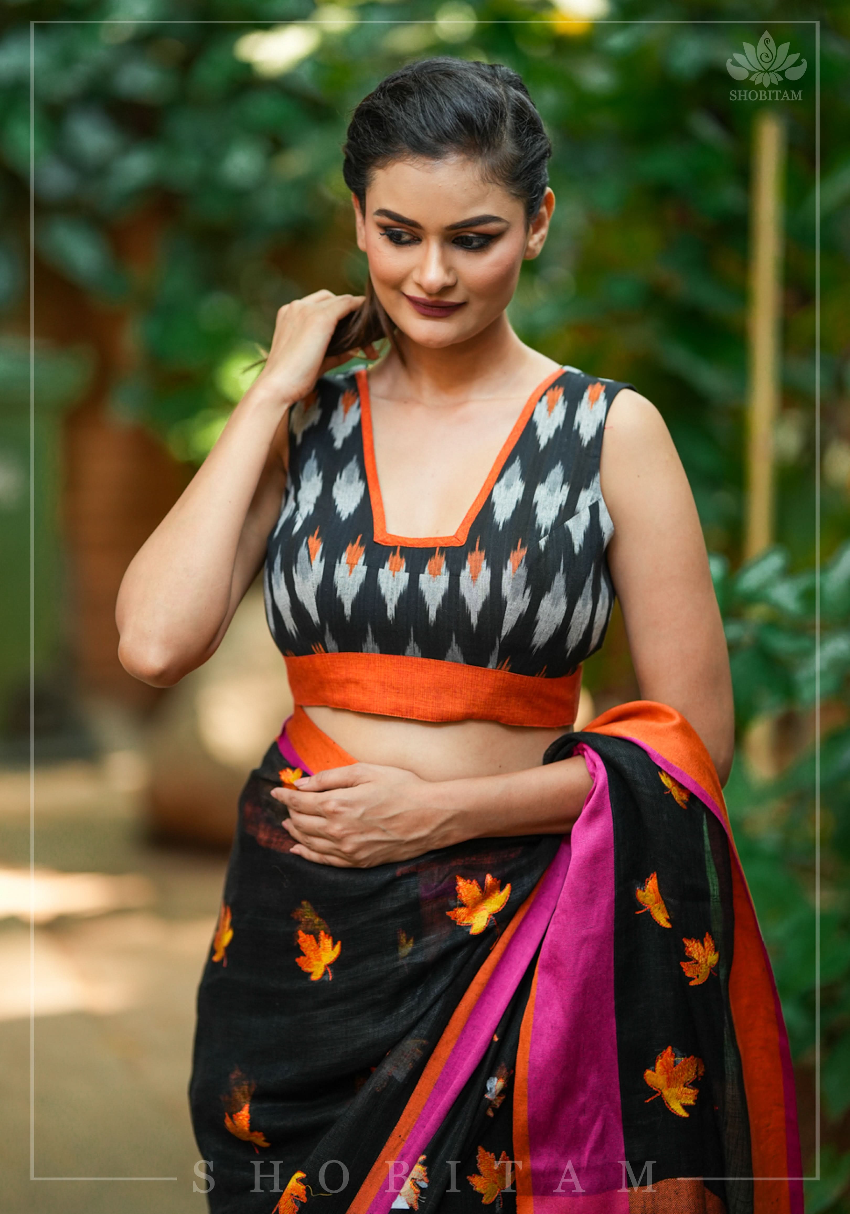 Black and orange cotton Ikkat square neck sleeveless blouse with orange handloom border. | Shobitam
