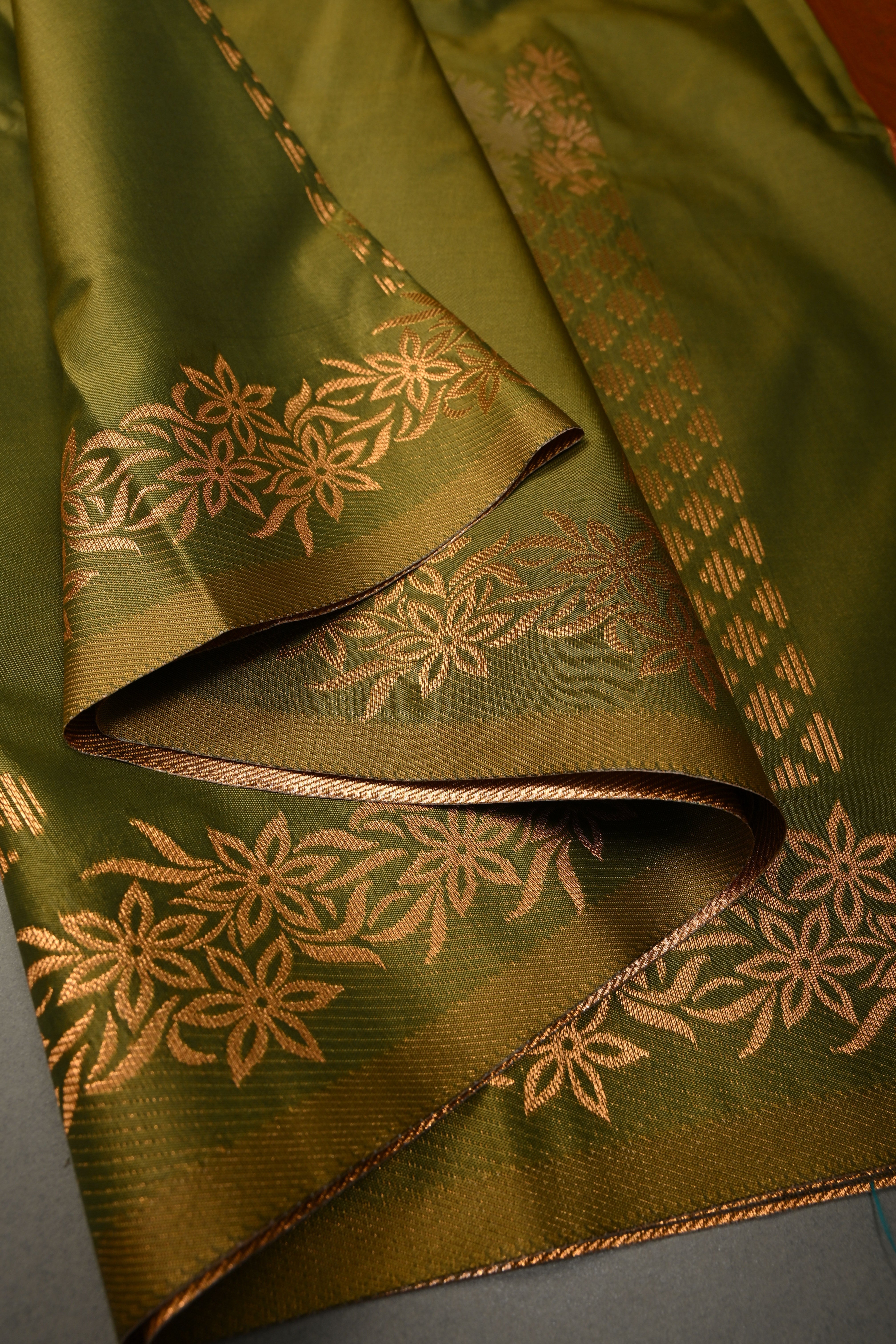 Henna Green Kanchi Semi Silk Saree with Floral Zari Buttas and Gold-Silver Motifs on Border | Shobitam