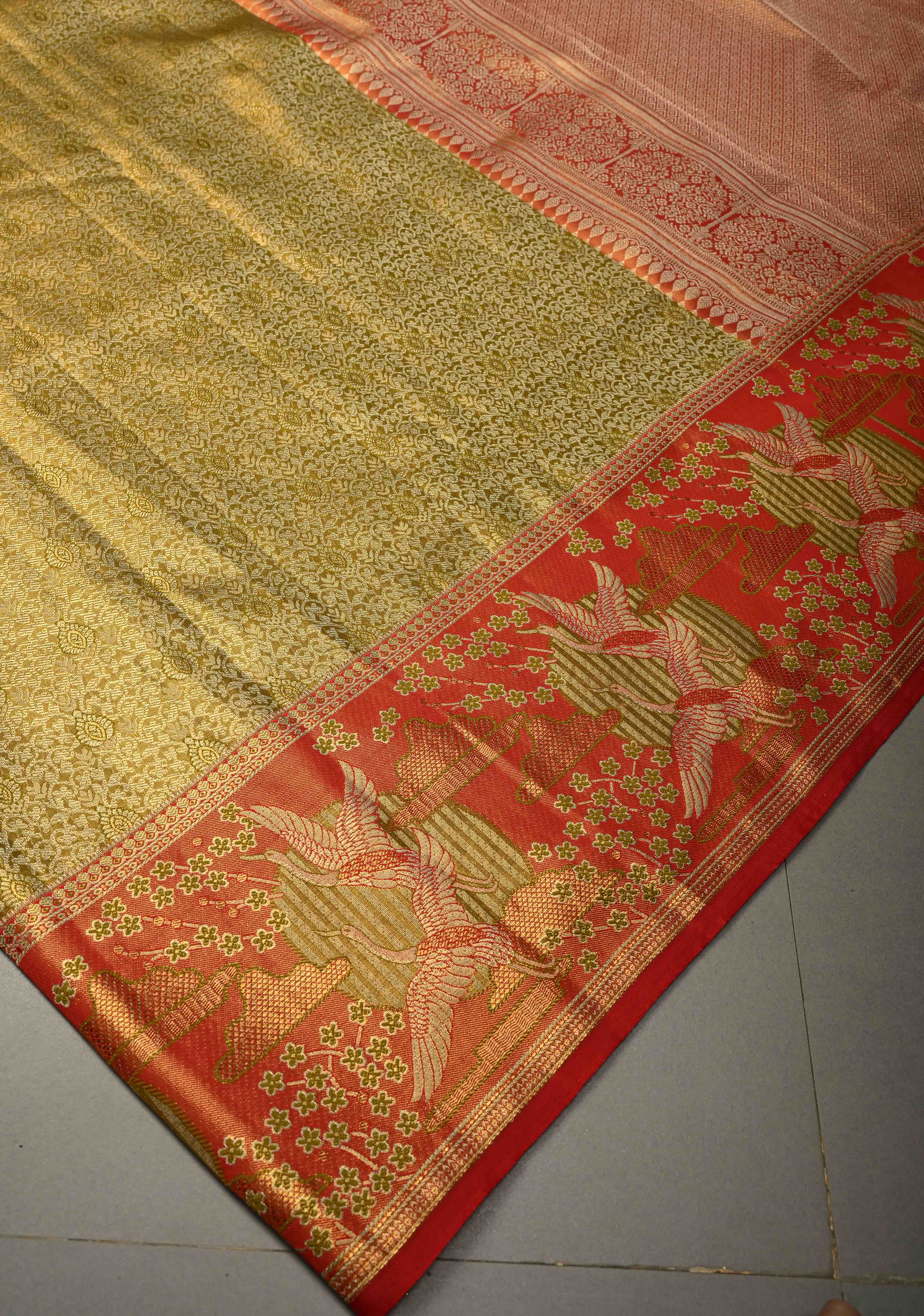 Ollive Green Kanjivaram Tissue Semi Silk Saree with Meenakari Floral Brocade Jaal and Contrast Zari Border | Shobitam