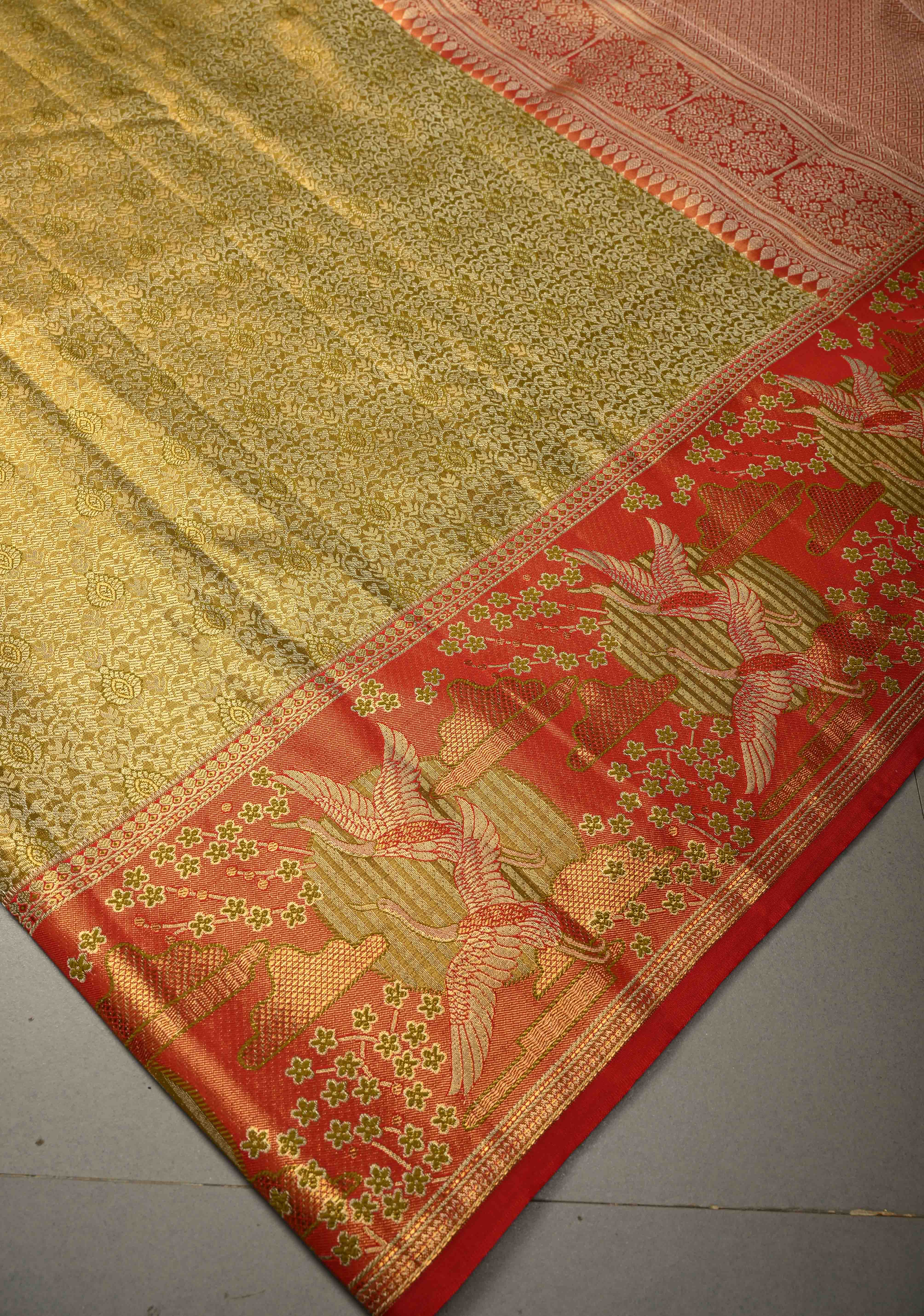 Ollive Green Kanjivaram Tissue Semi Silk Saree with Meenakari Floral Brocade Jaal and Contrast Zari Border | Shobitam