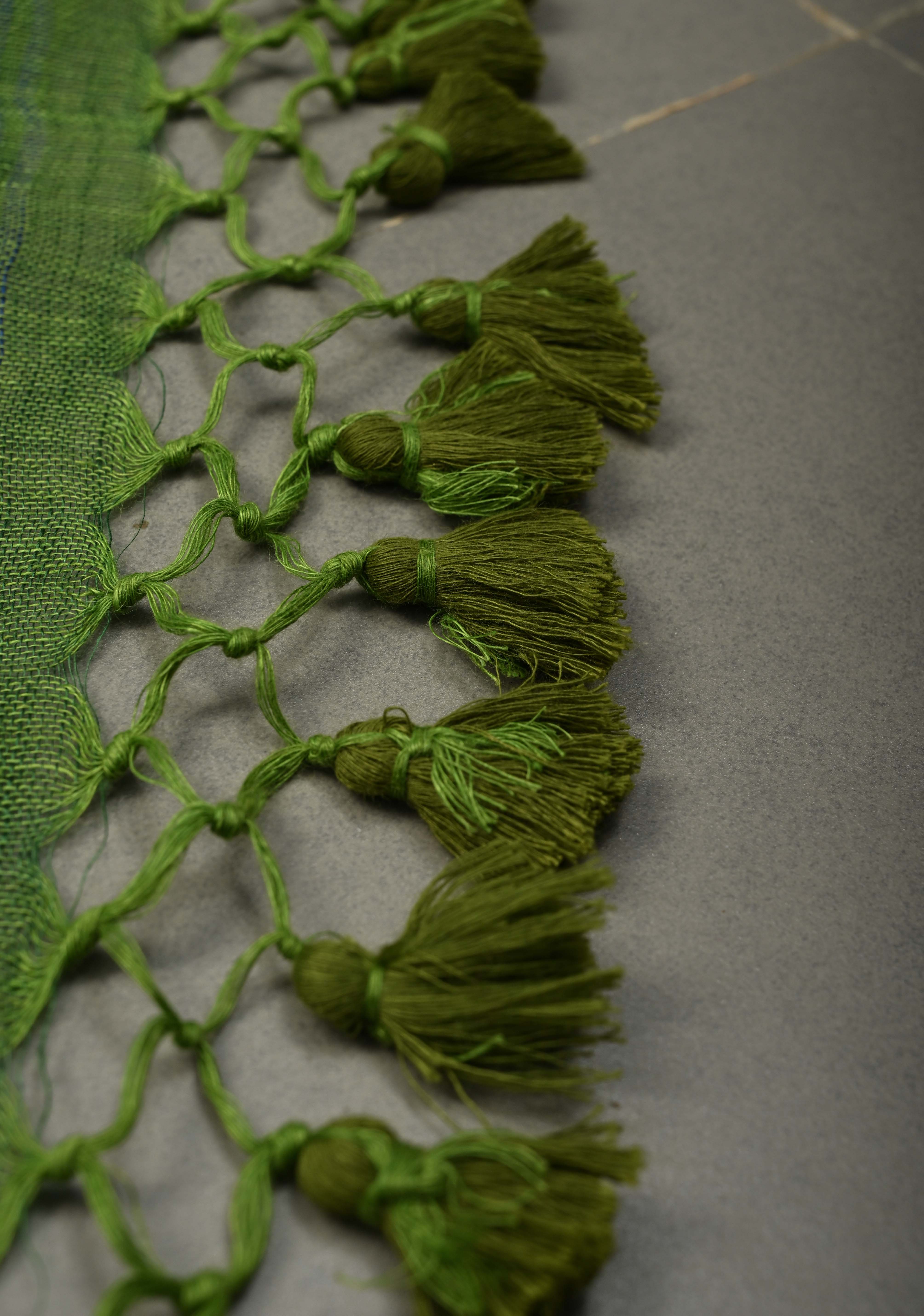 Grass Green Handloom Linen by Linen Saree with Minimal Tissue Border and Honeycomb Tassels | Shobitam