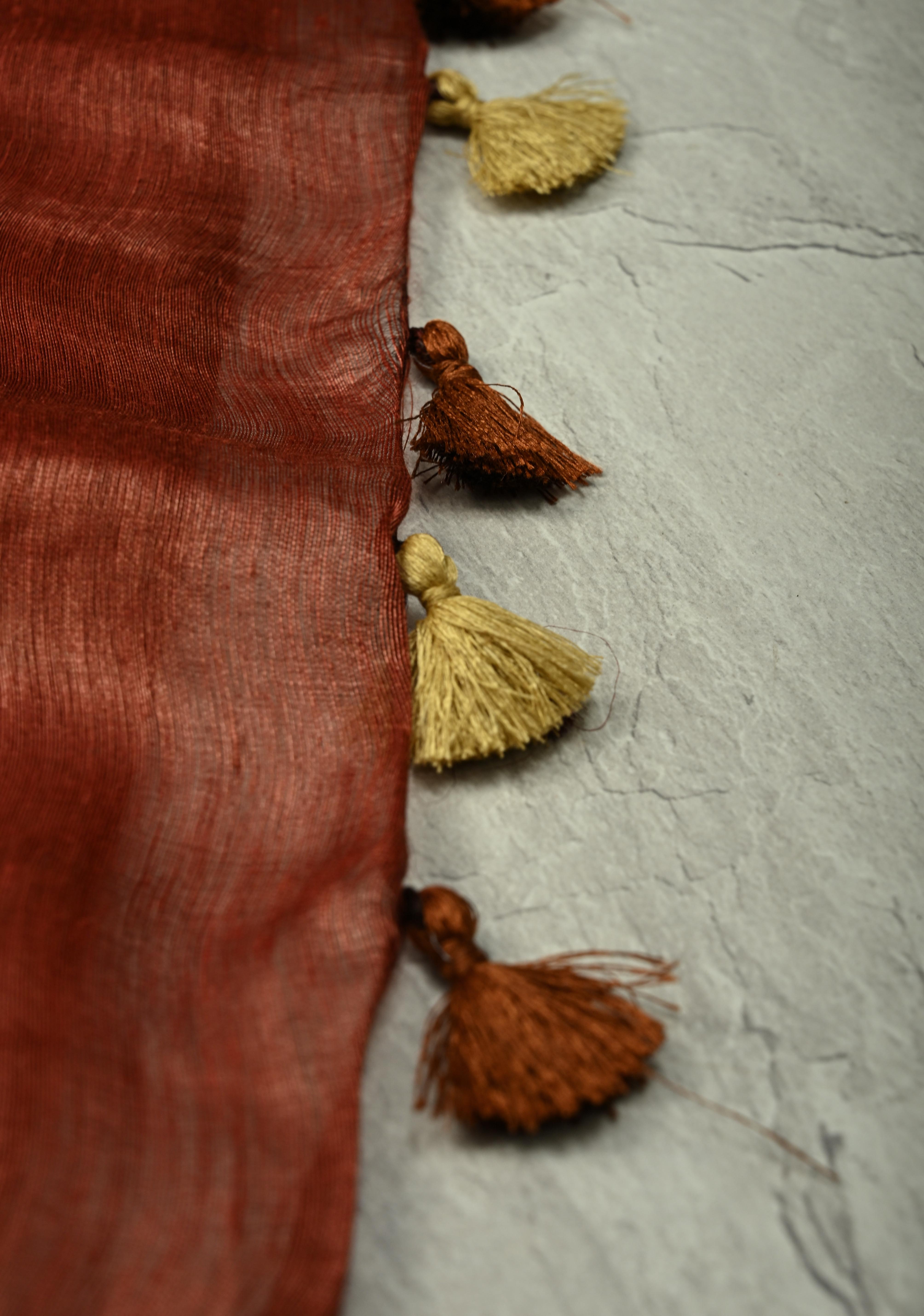 Copper Rust Silk Linen Saree with Muted Tissue Border and Floral Buttas on Pallu | Shobitam