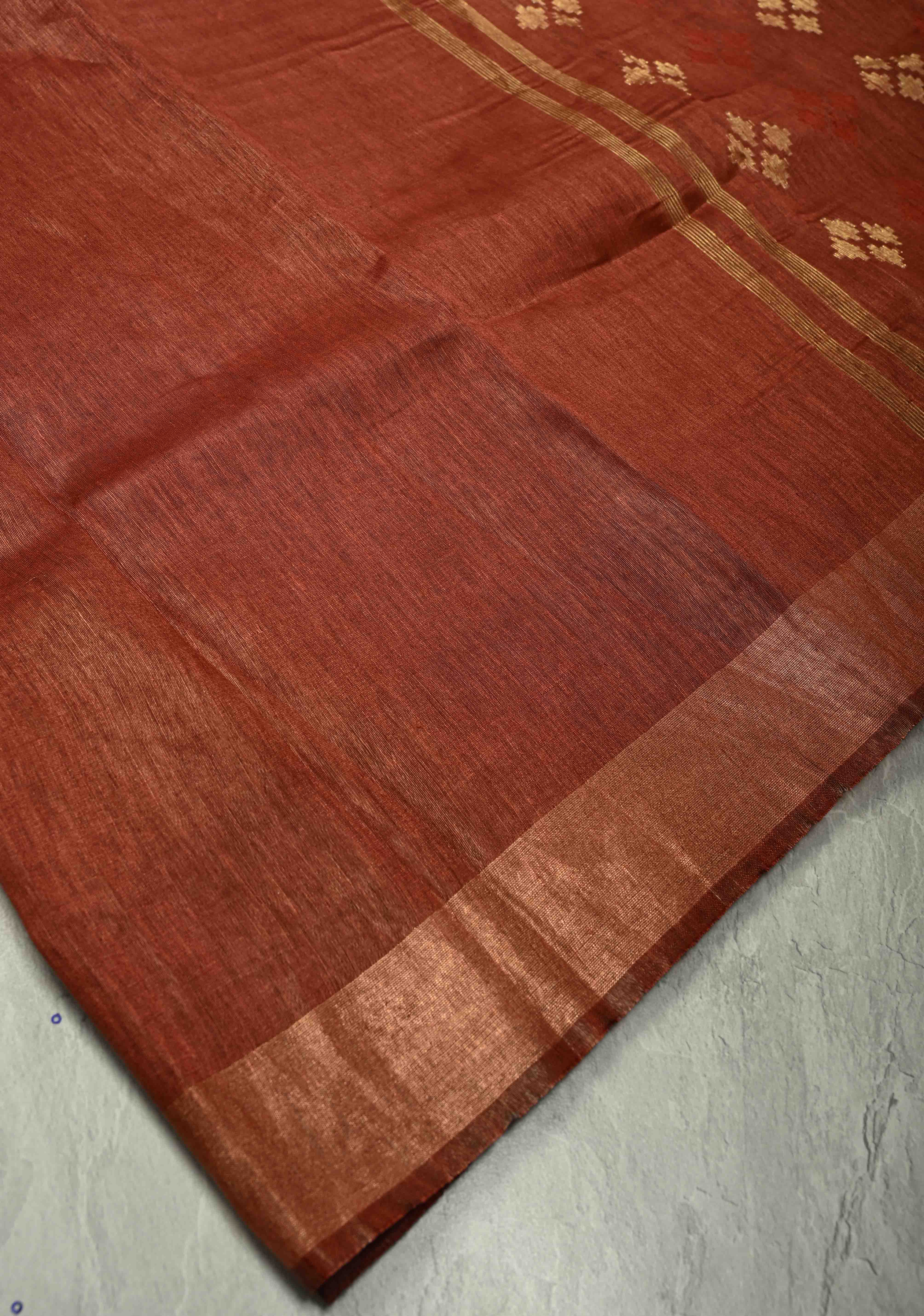 Copper Rust Silk Linen Saree with Muted Tissue Border and Floral Buttas on Pallu | Shobitam