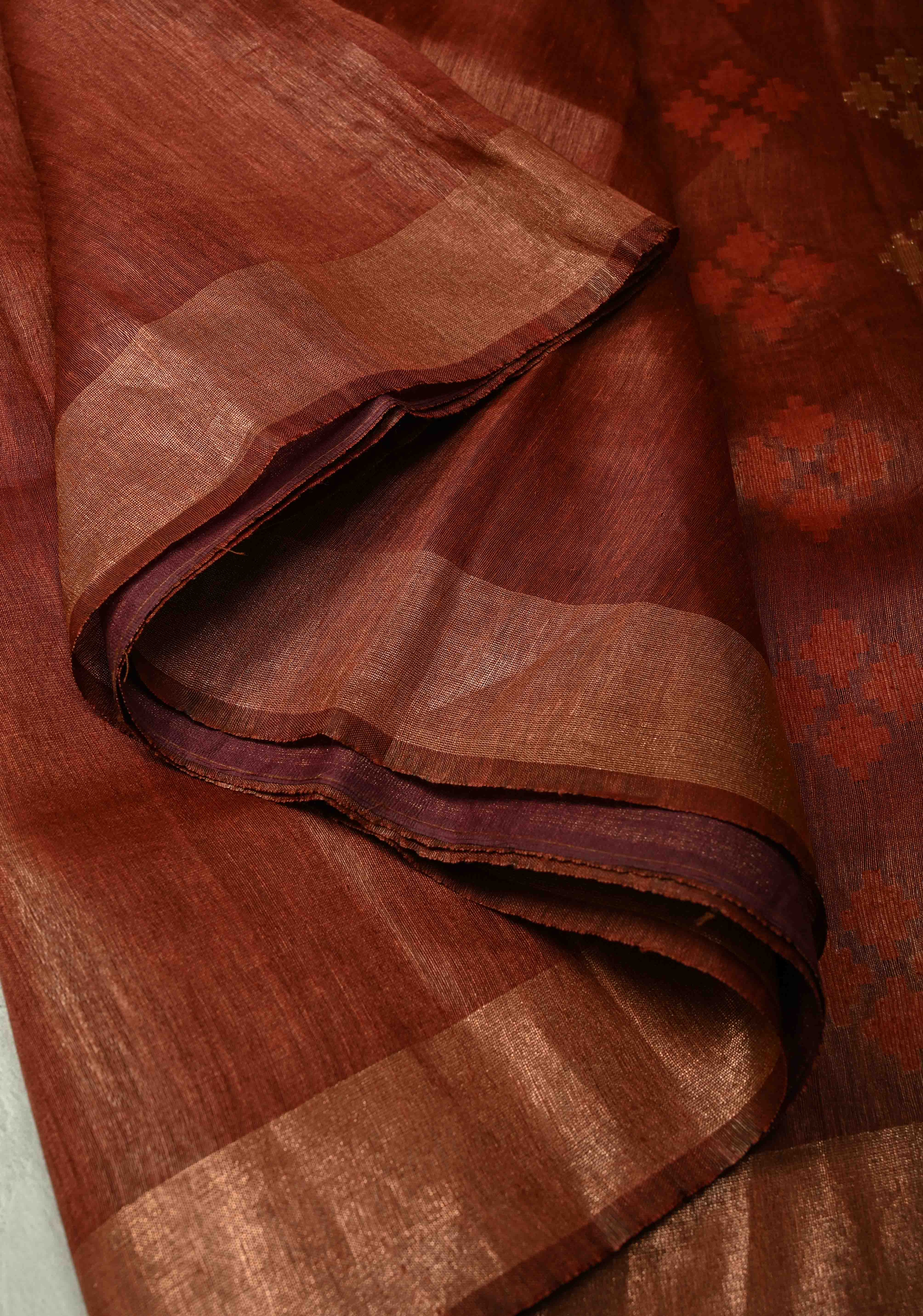 Copper Rust Silk Linen Saree with Muted Tissue Border and Floral Buttas on Pallu | Shobitam