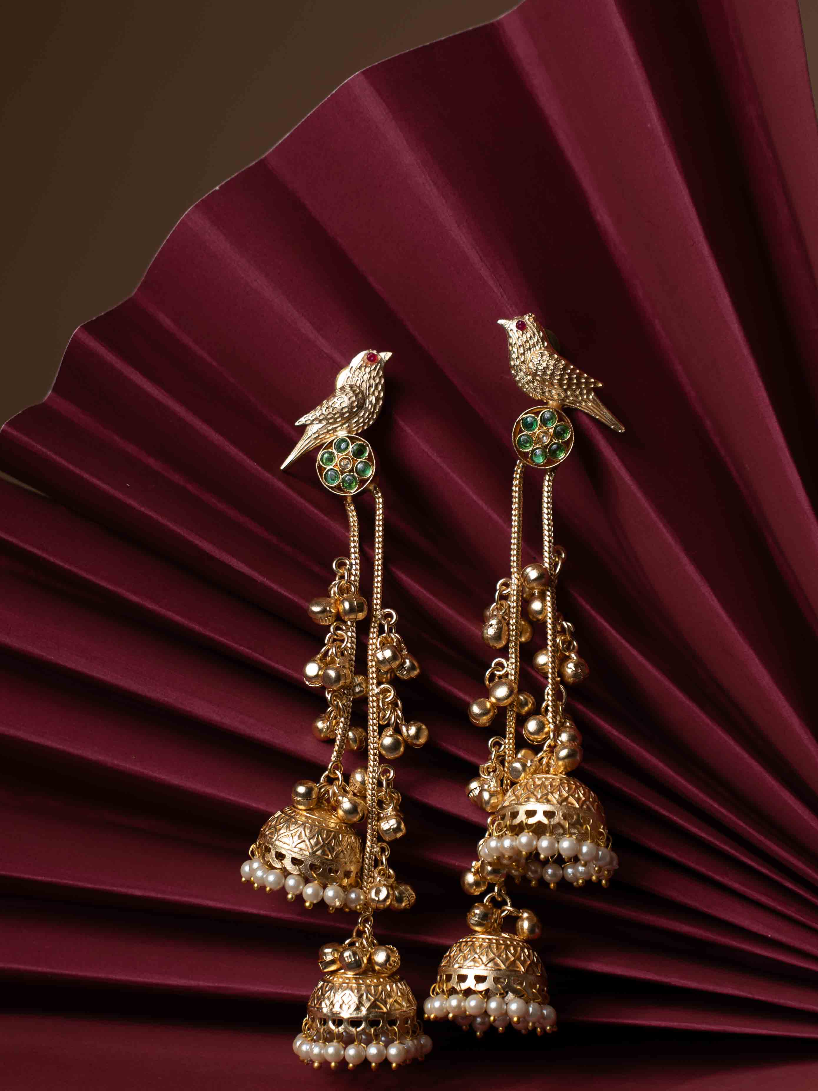 Gold Plated Bird Motif Long Jhumka Earrings with Pearl Drops & Green Stone Accents