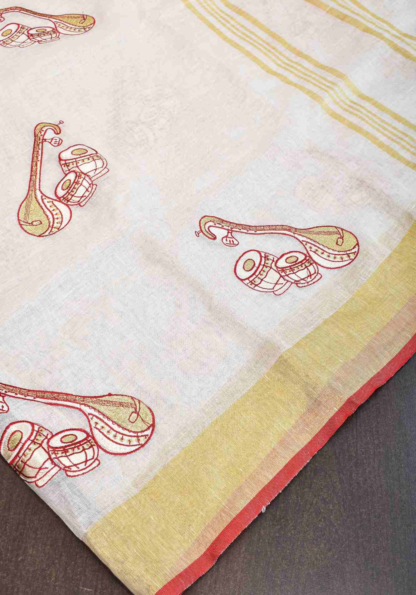 Linen by Linen Saree in White with Musical instruments embroidery motifs