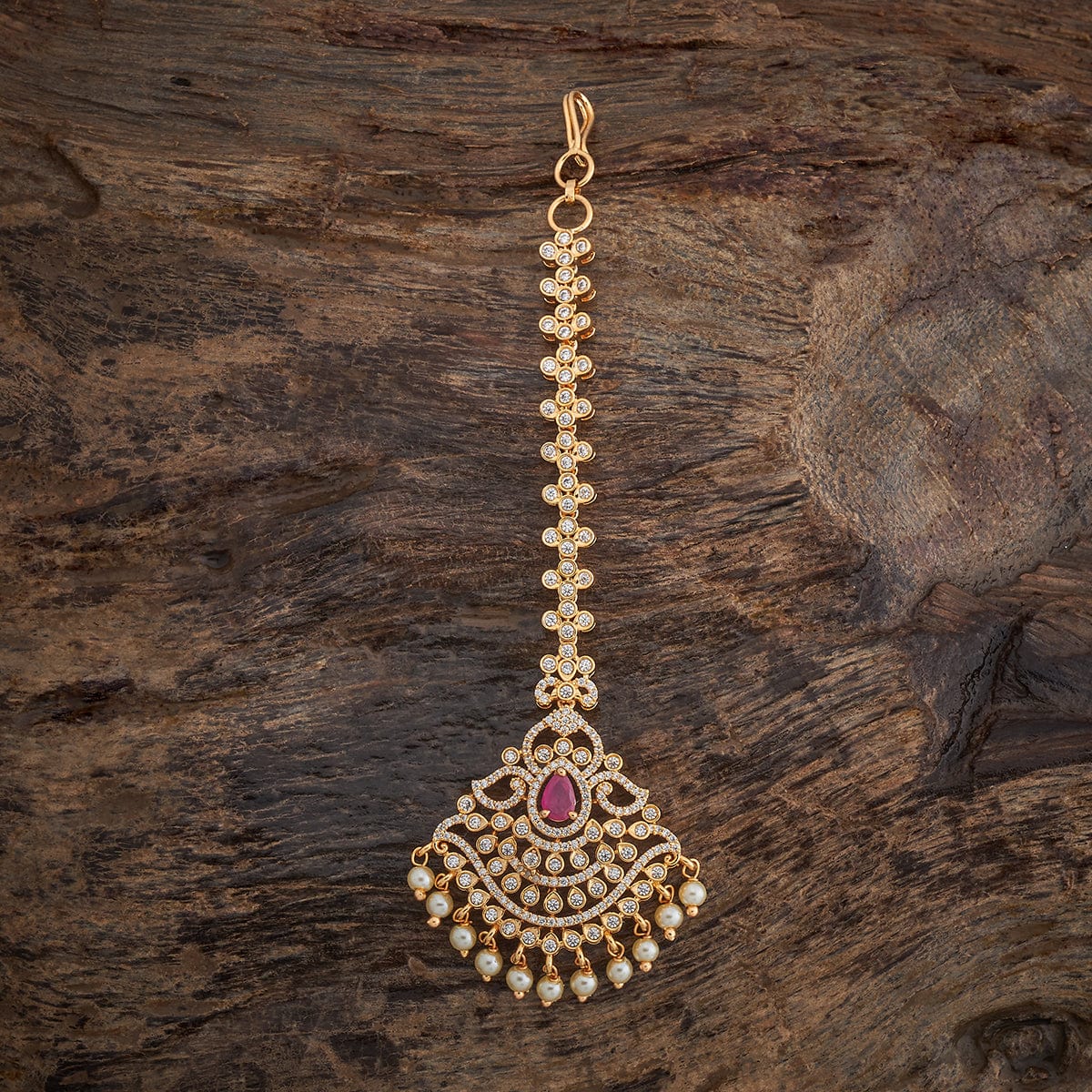 Traditional Design Tikka with shimmering White Ruby stones and beads finished in luxurious gold polish | sHOBITAM