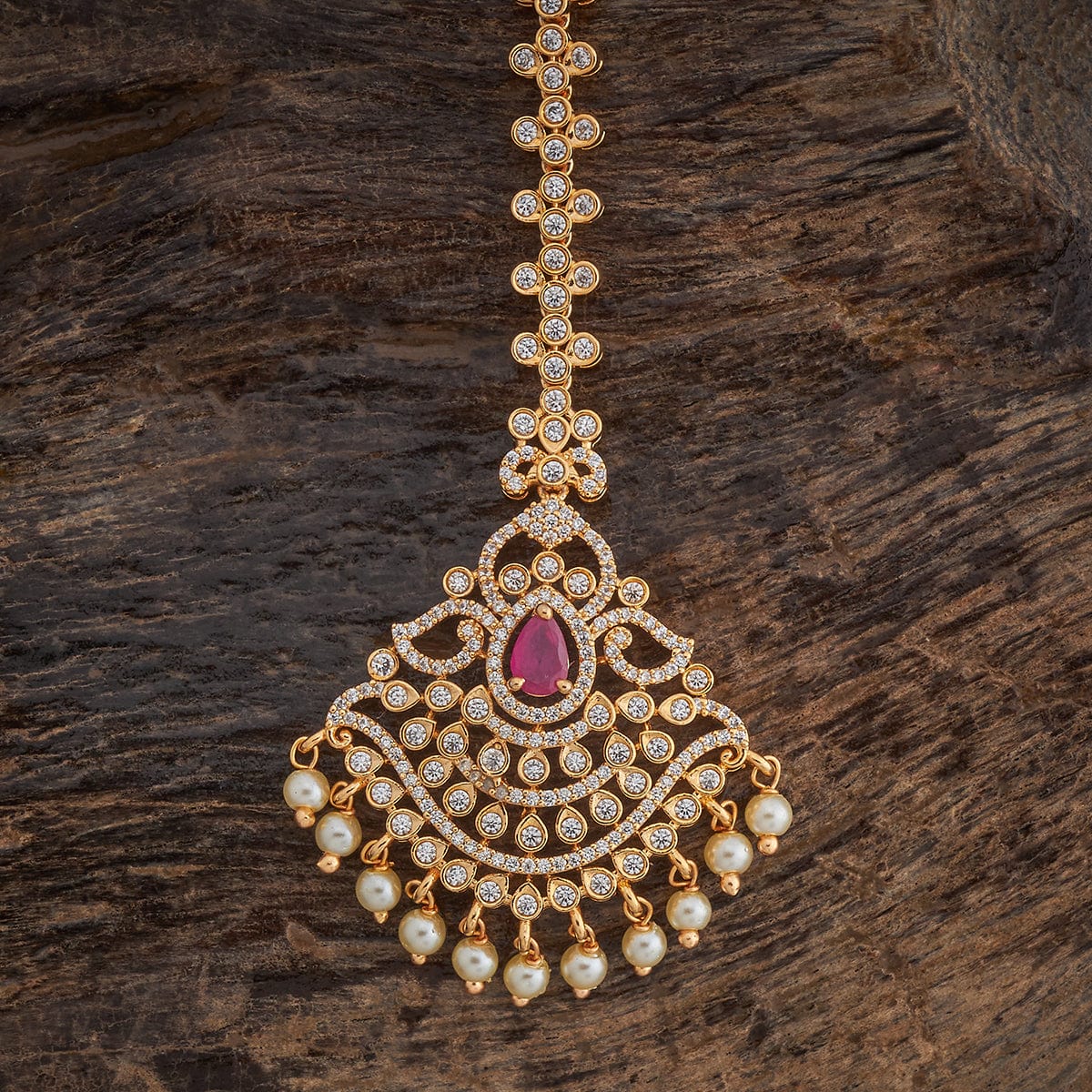 Traditional Design Tikka with shimmering White Ruby stones and beads finished in luxurious gold polish | sHOBITAM